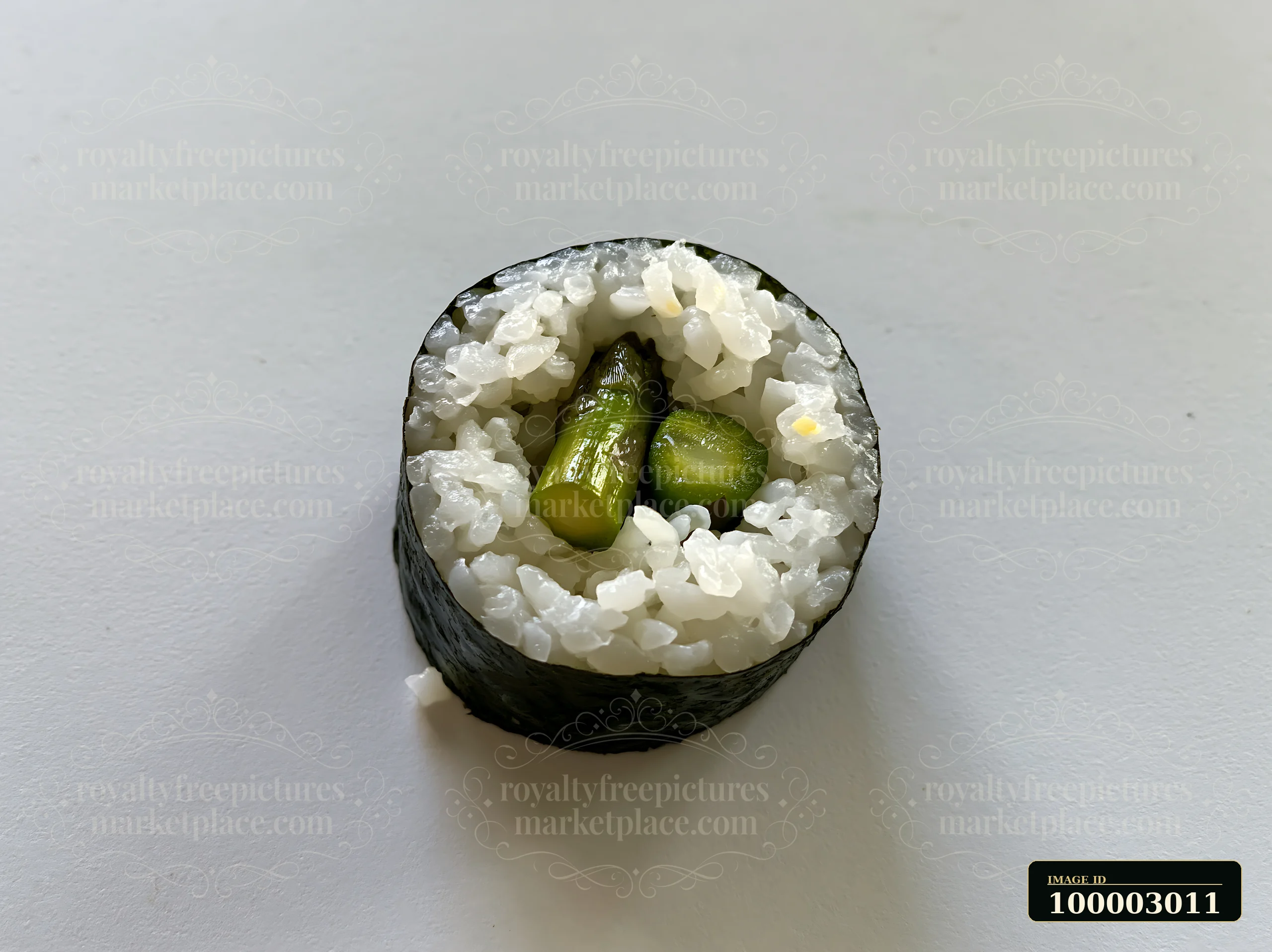 A single sushi piece rests on a plain table surface.
