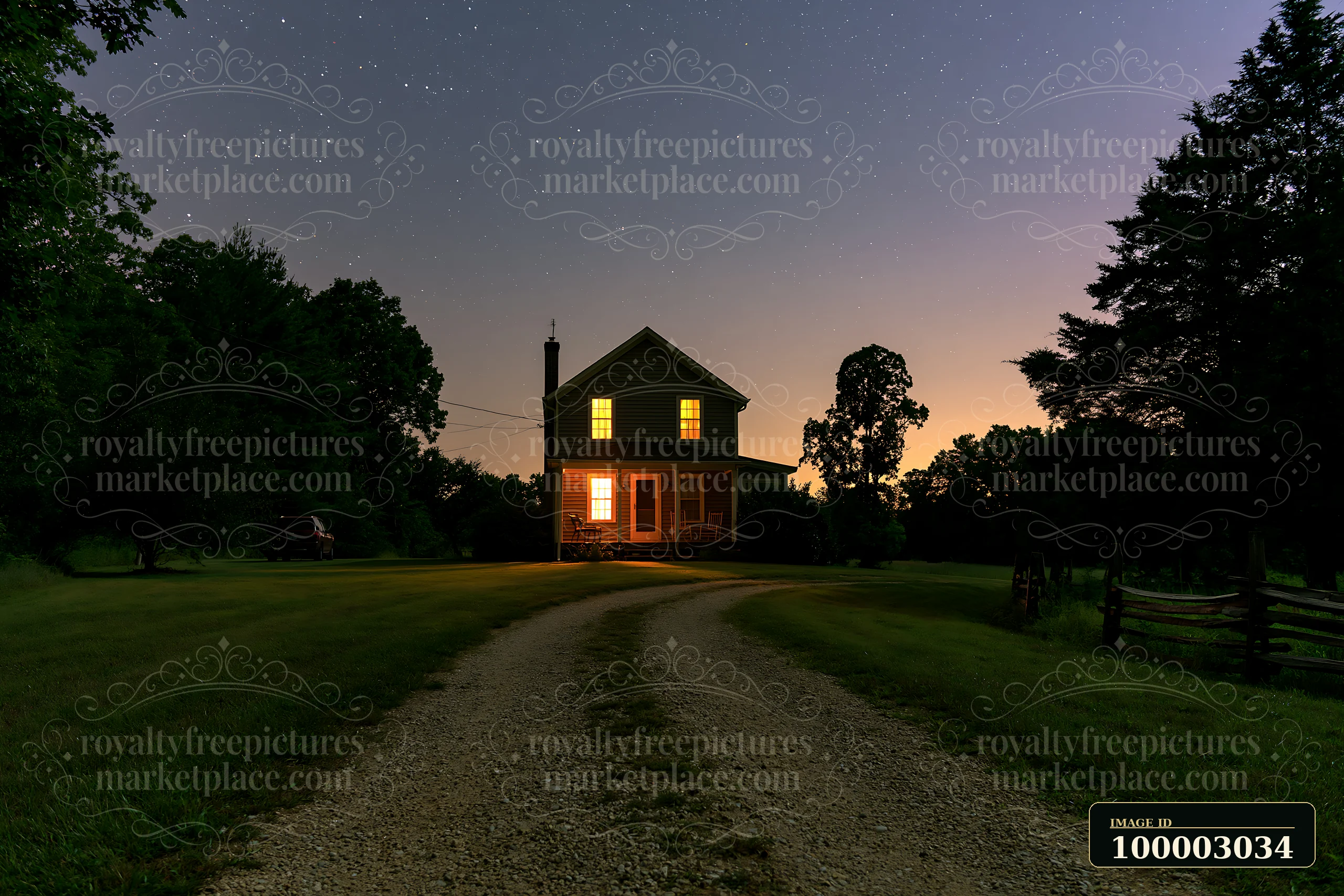 A country house stands under a starry sky with its lights glowing warmly.