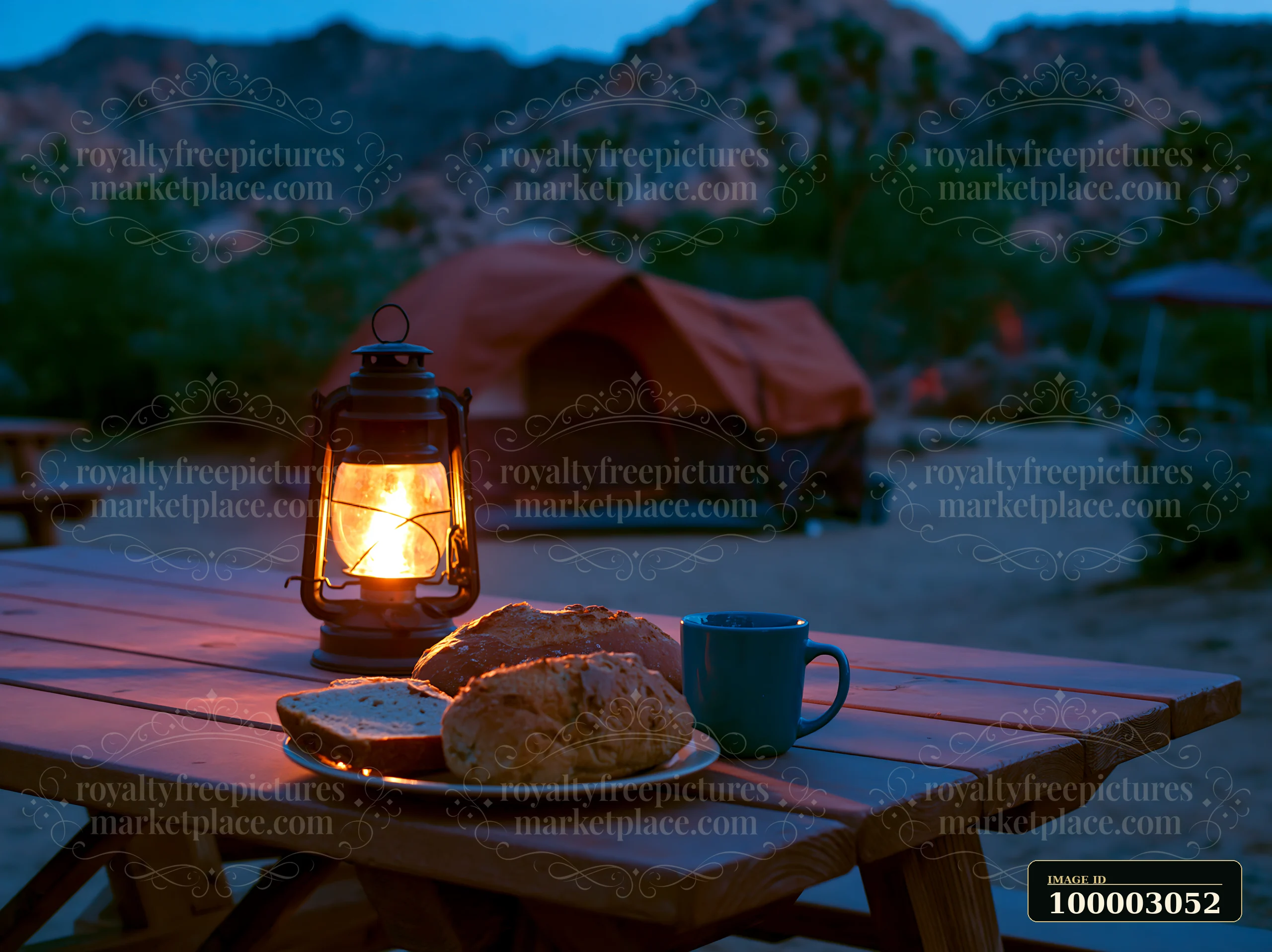 A lantern lights the table with bread while a tent stands under the starry night sky in a desert setting.