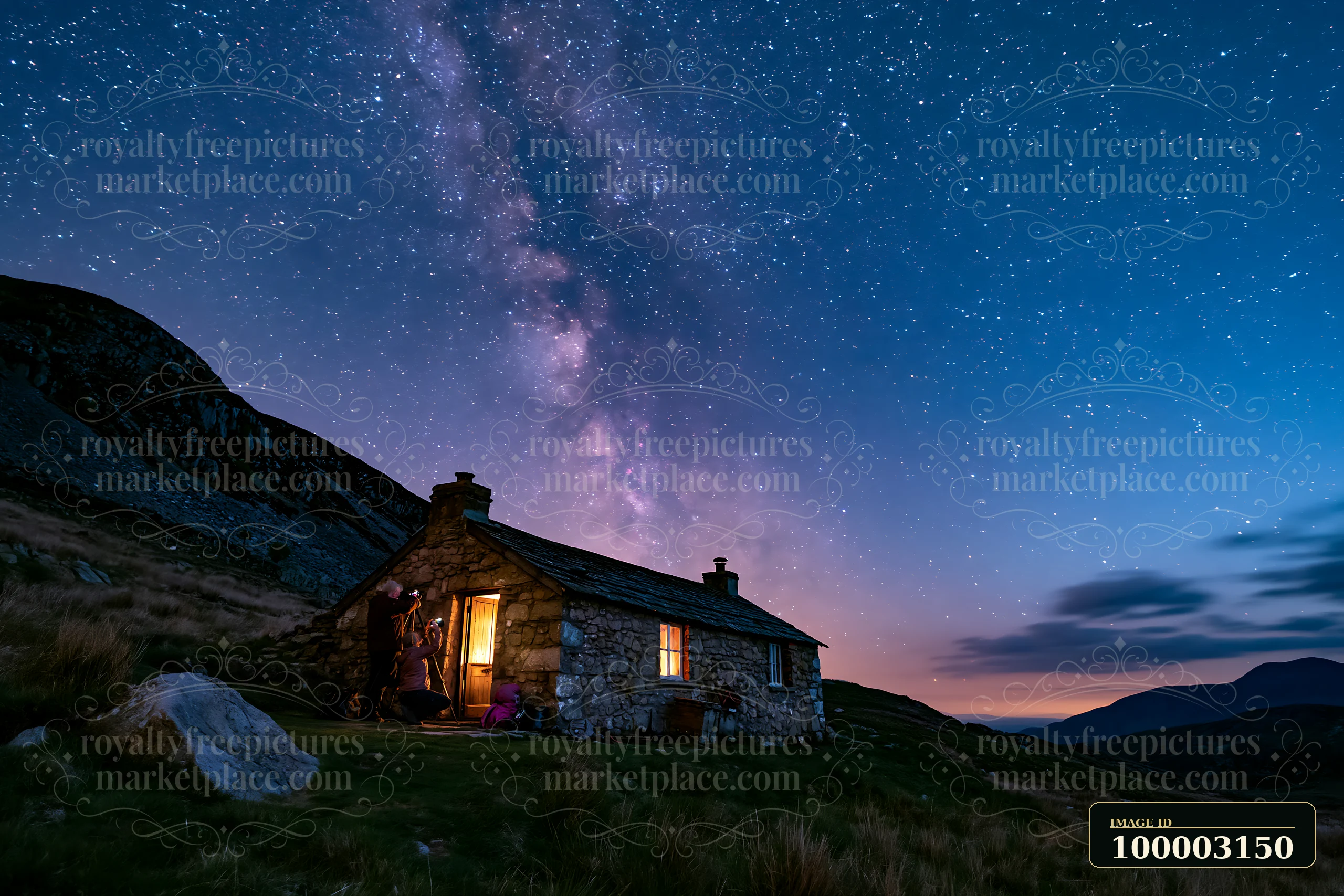 A couple is photographing the Milky Way next to a stone cabin in the mountains at night.