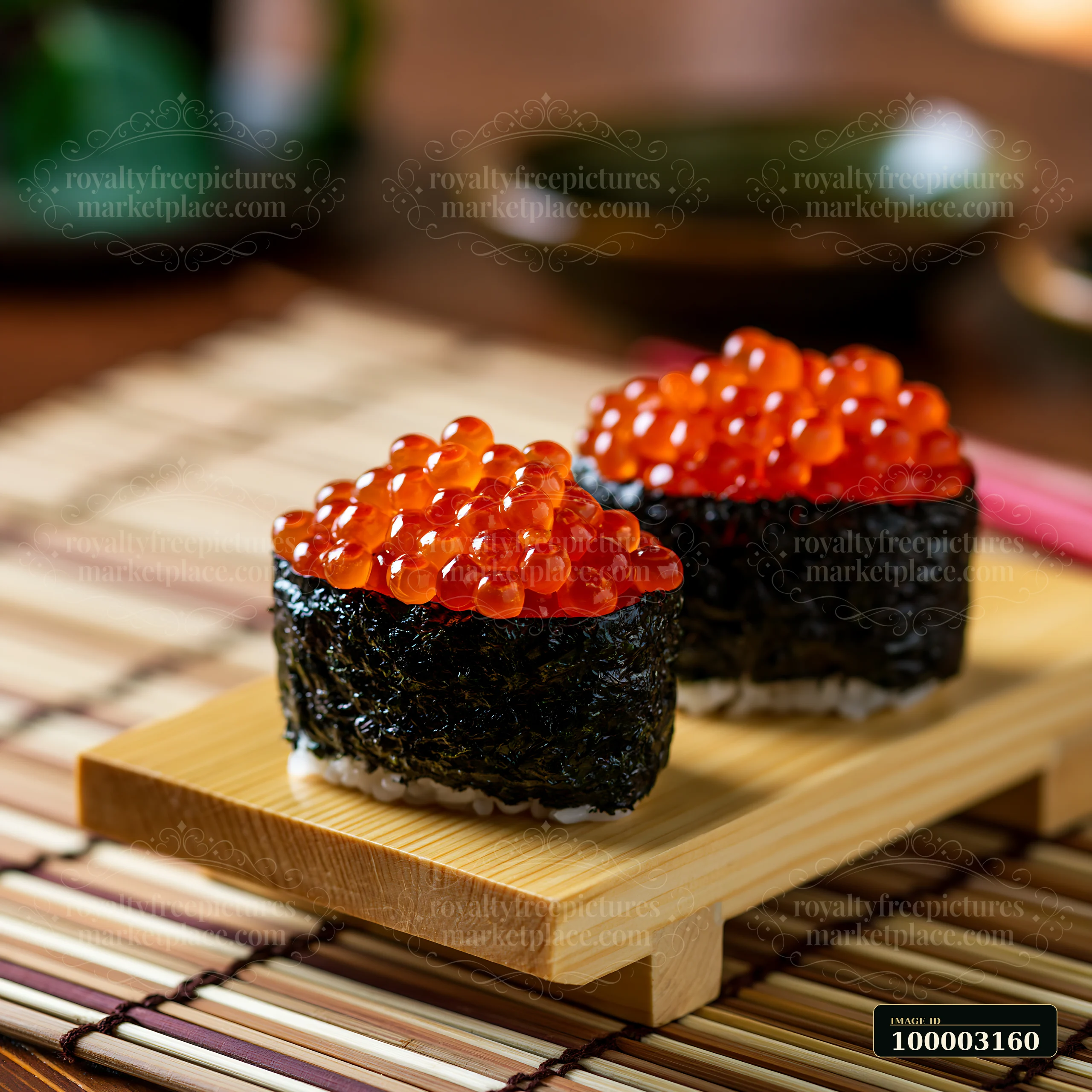 Ikura salmon roe sushi is placed on a bamboo mat.