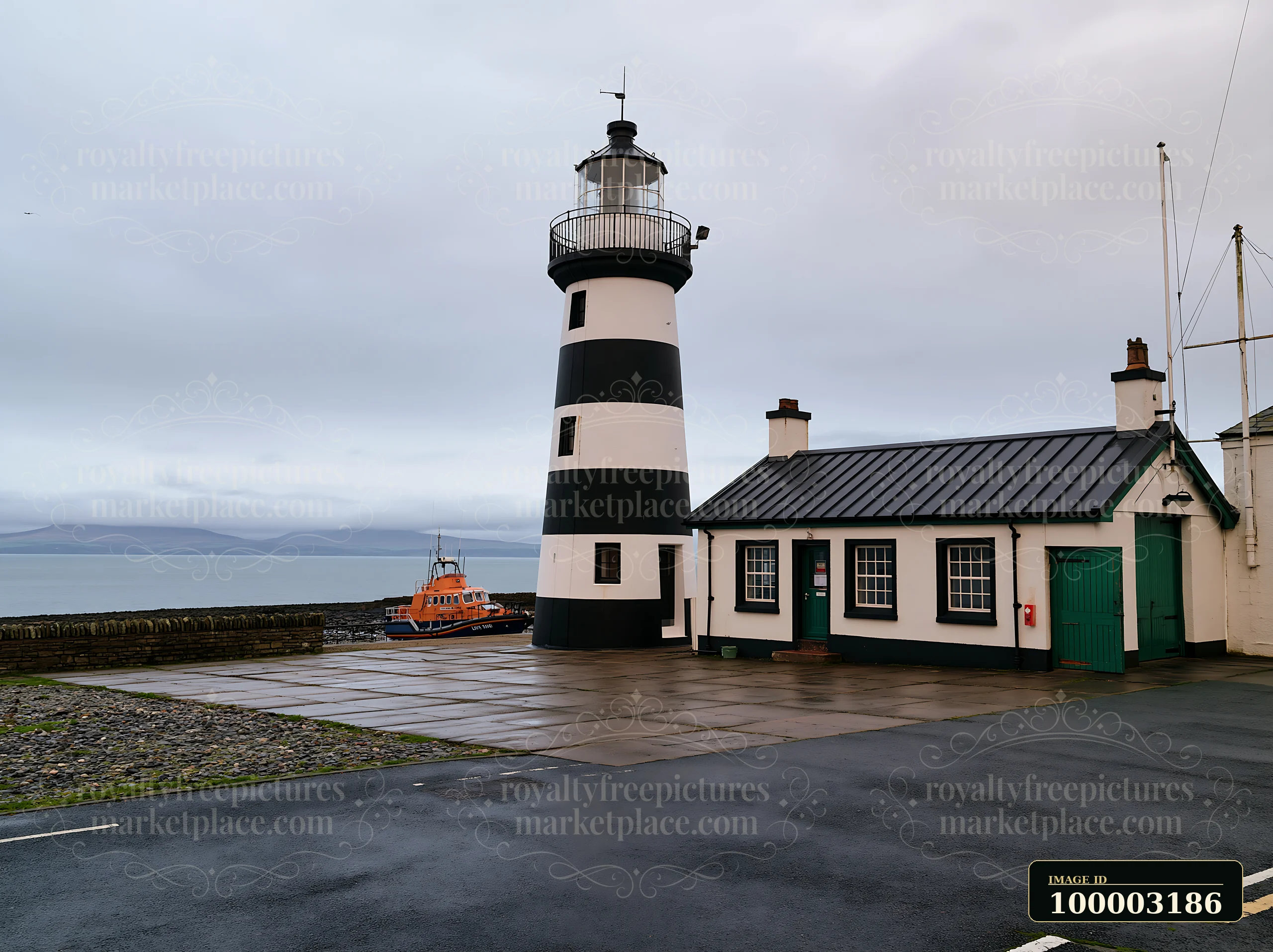 A lighthouse with black and white stripes stands by the sea, next to a small building and an orange boat.