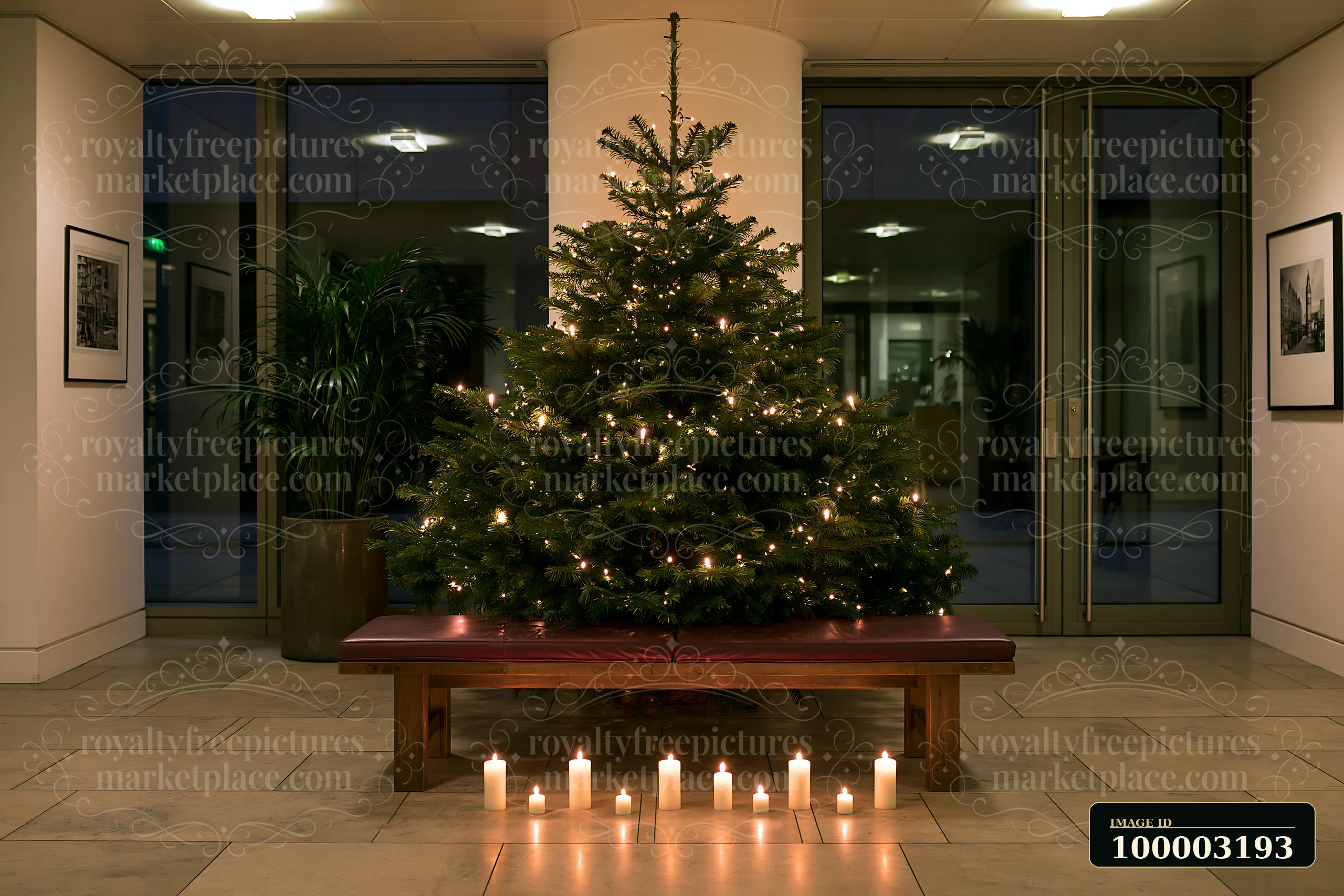 A Christmas tree with candles nearby stands in a well-lit lobby area.