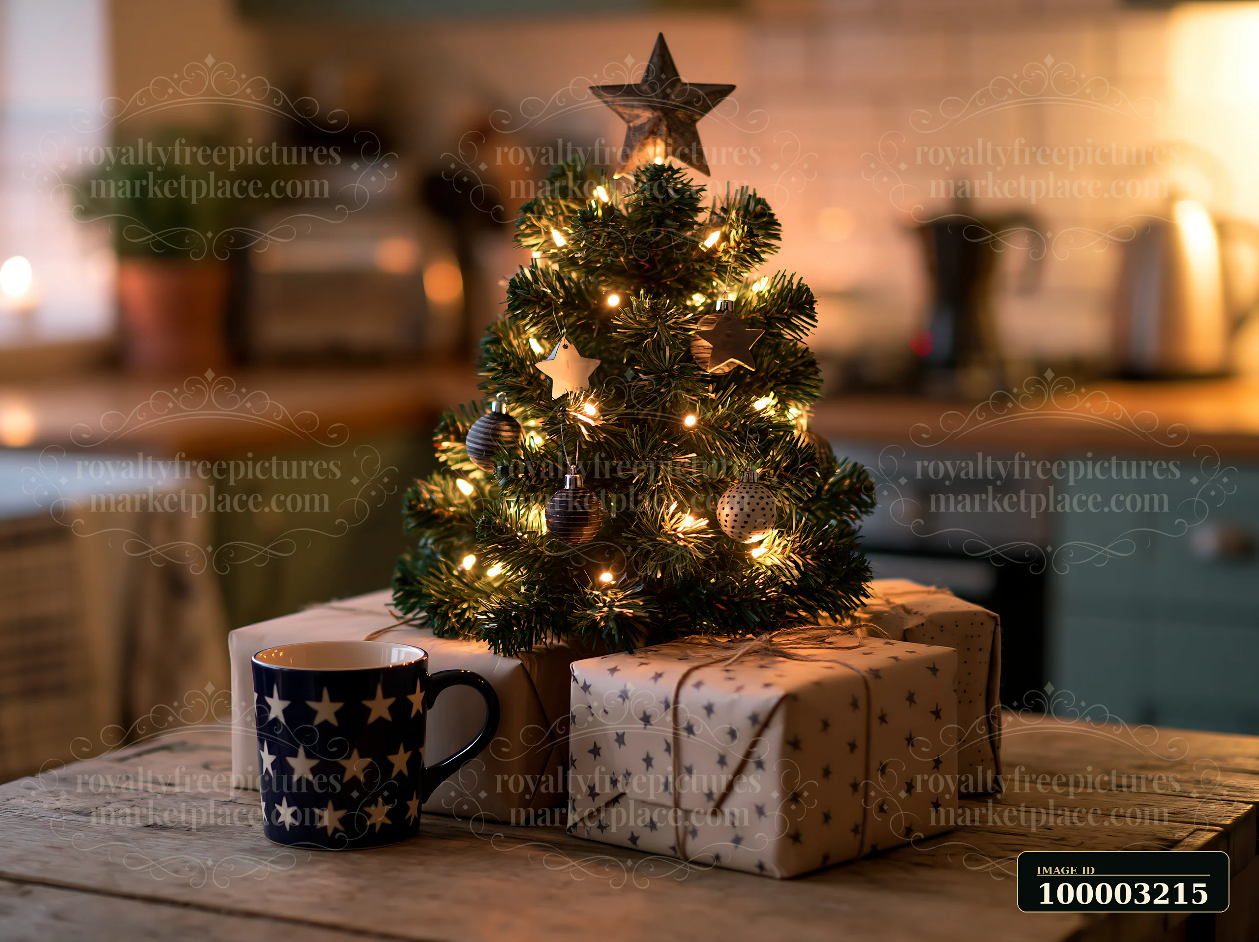 A small Christmas tree with monochrome decorations is placed on a wooden table surrounded by wrapped gifts, adding a festive touch to a cozy kitchen setting.
