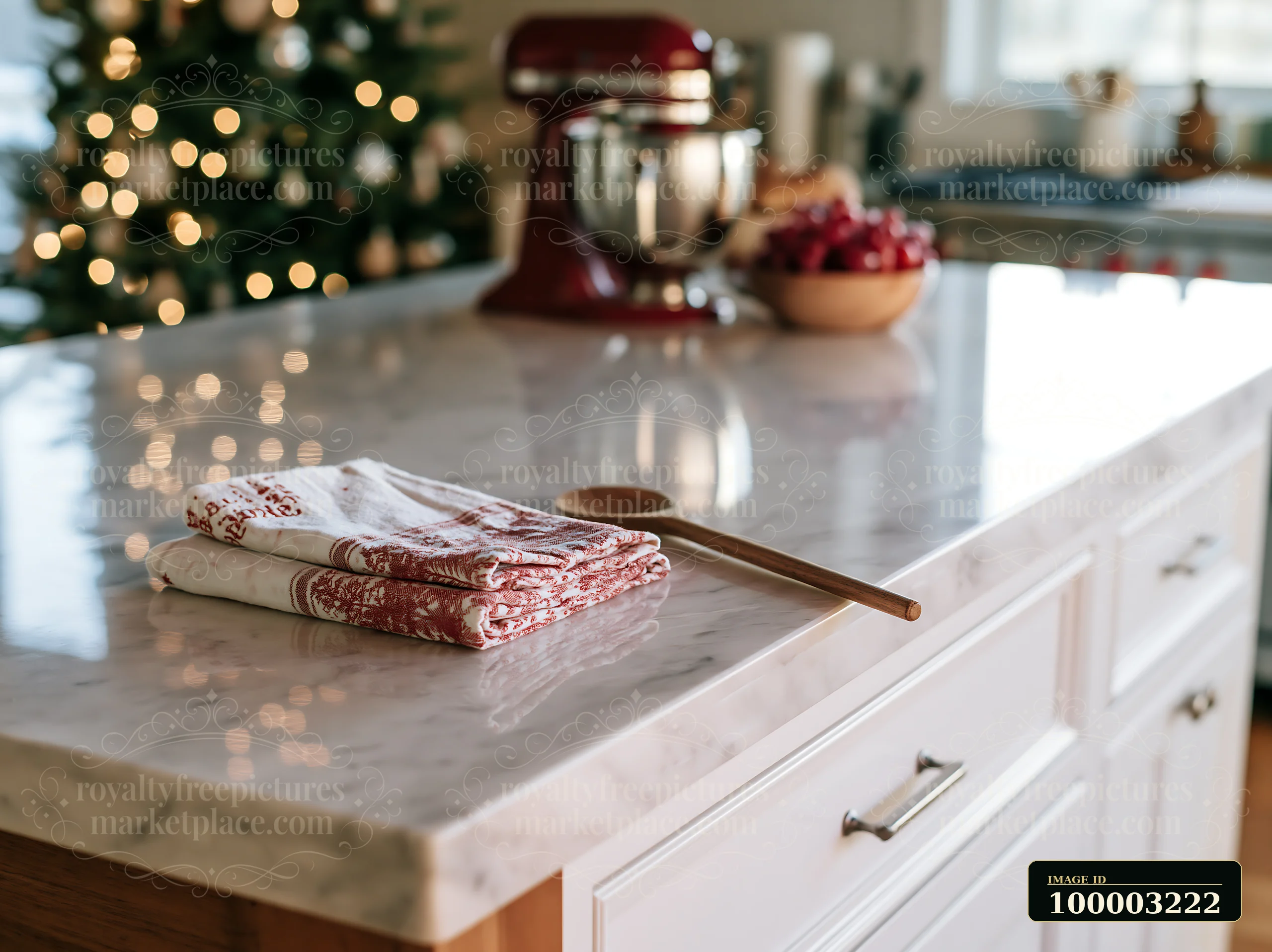 A sleek kitchen countertop features a wooden spoon and folded dish towels.