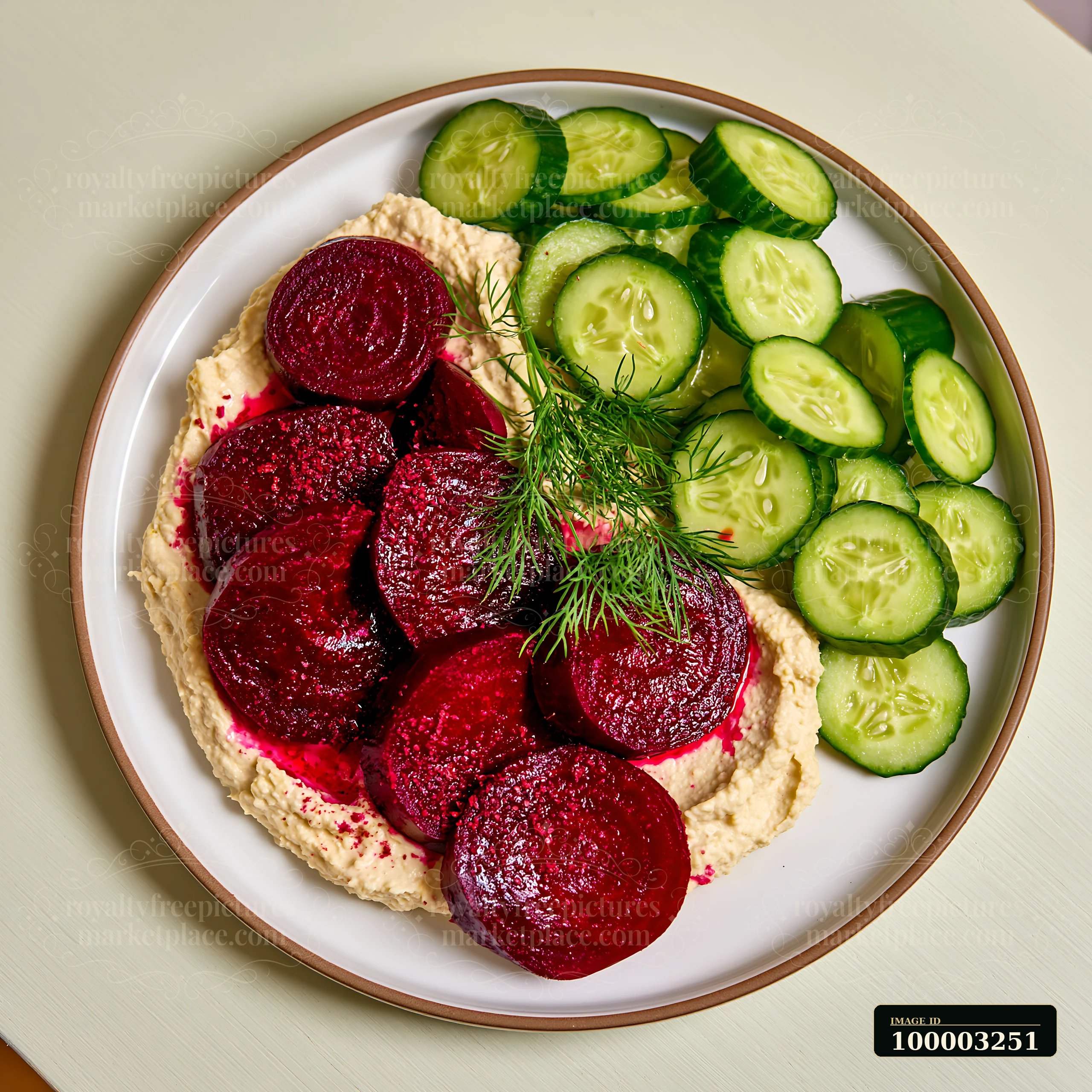 A breakfast plate features hummus topped with beetroot slices and cucumber on the side.