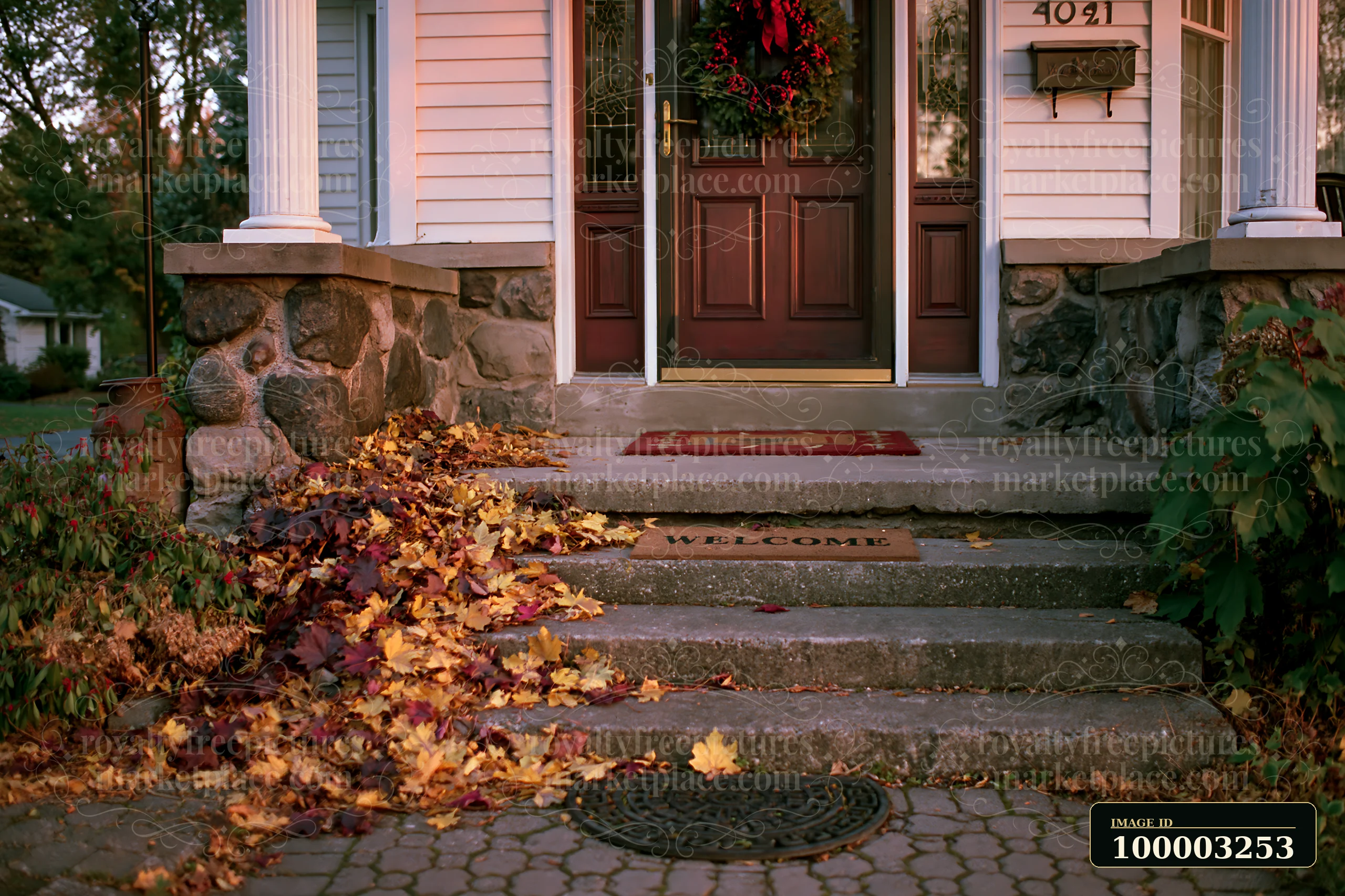 The scene shows a decorative glass front door adorned with a wreath.