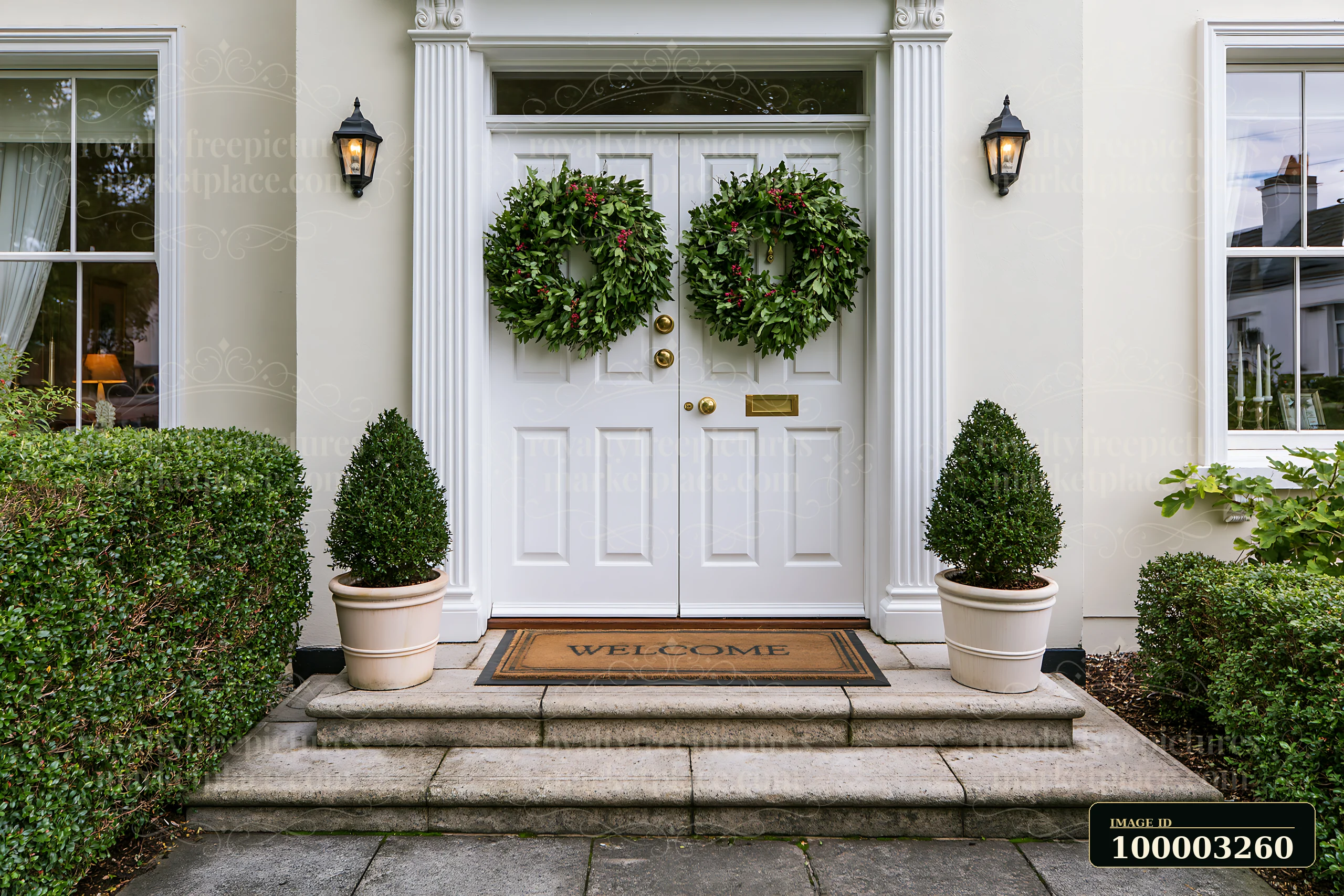 A front door with wreath and welcome doormat presents a warm entryway.