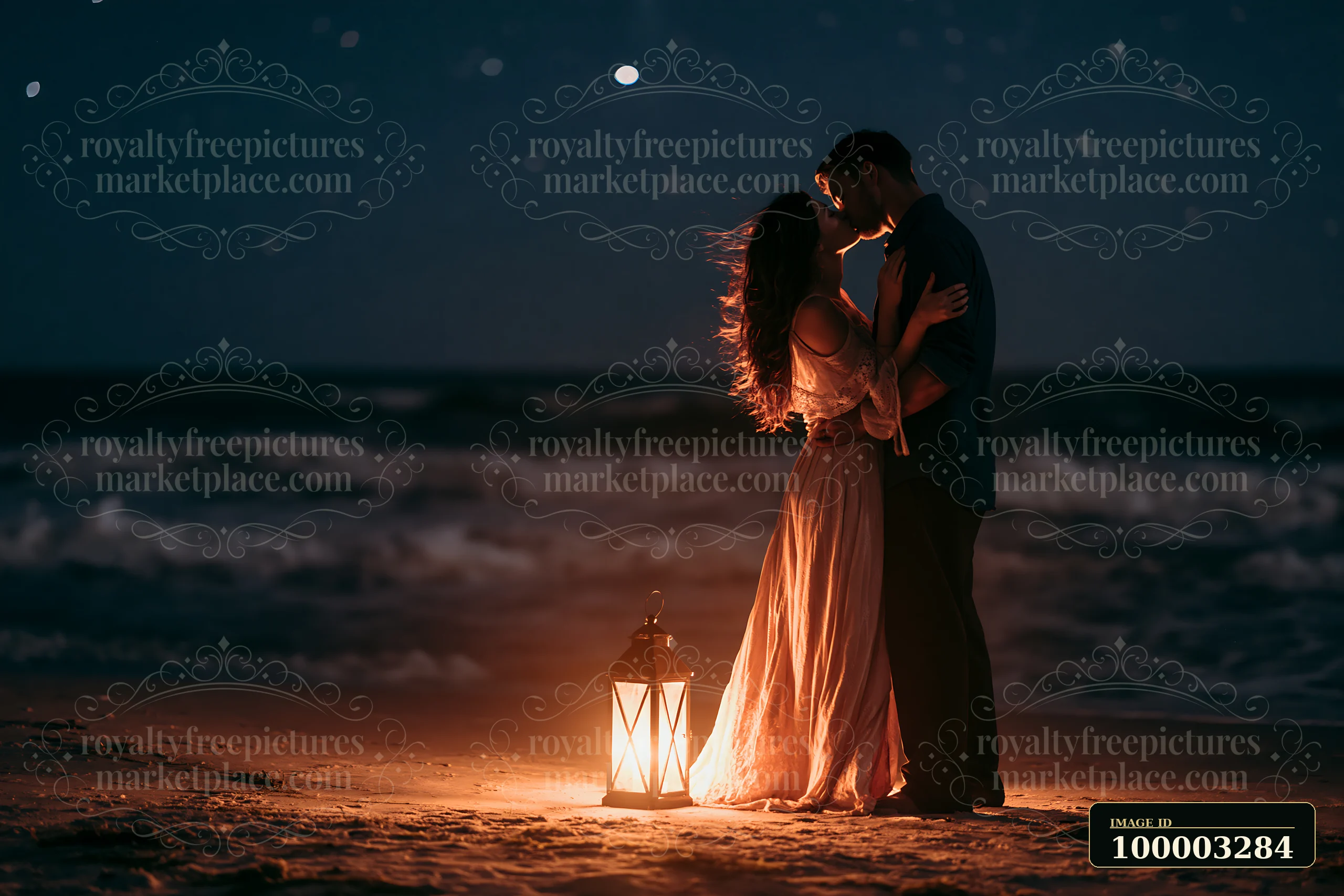 A couple kissing beneath stars beside a glowing lantern on a beach during the night.