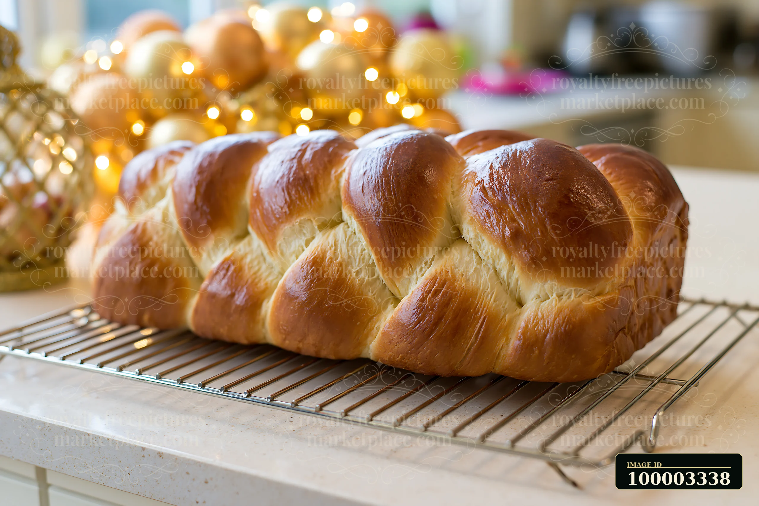 Decorative elements and warm lighting fill a high-end festive kitchen with elegant decorations, featuring a freshly baked braided bread on a cooling rack in the