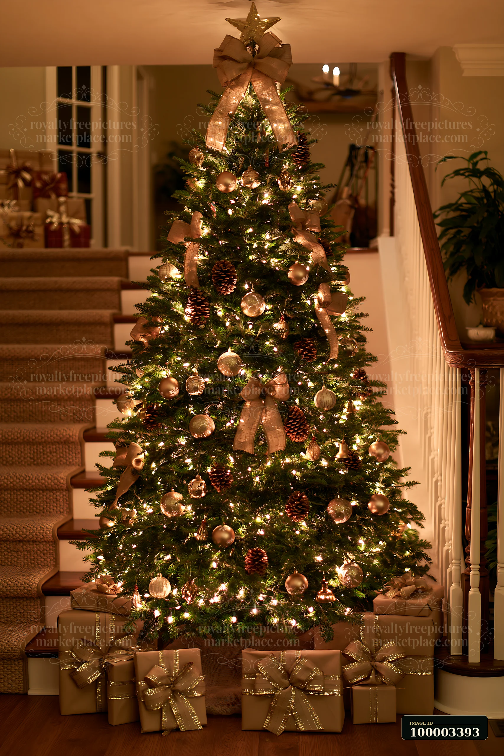 A Christmas tree decorated with burlap stands by a staircase, illuminated by warm lights.