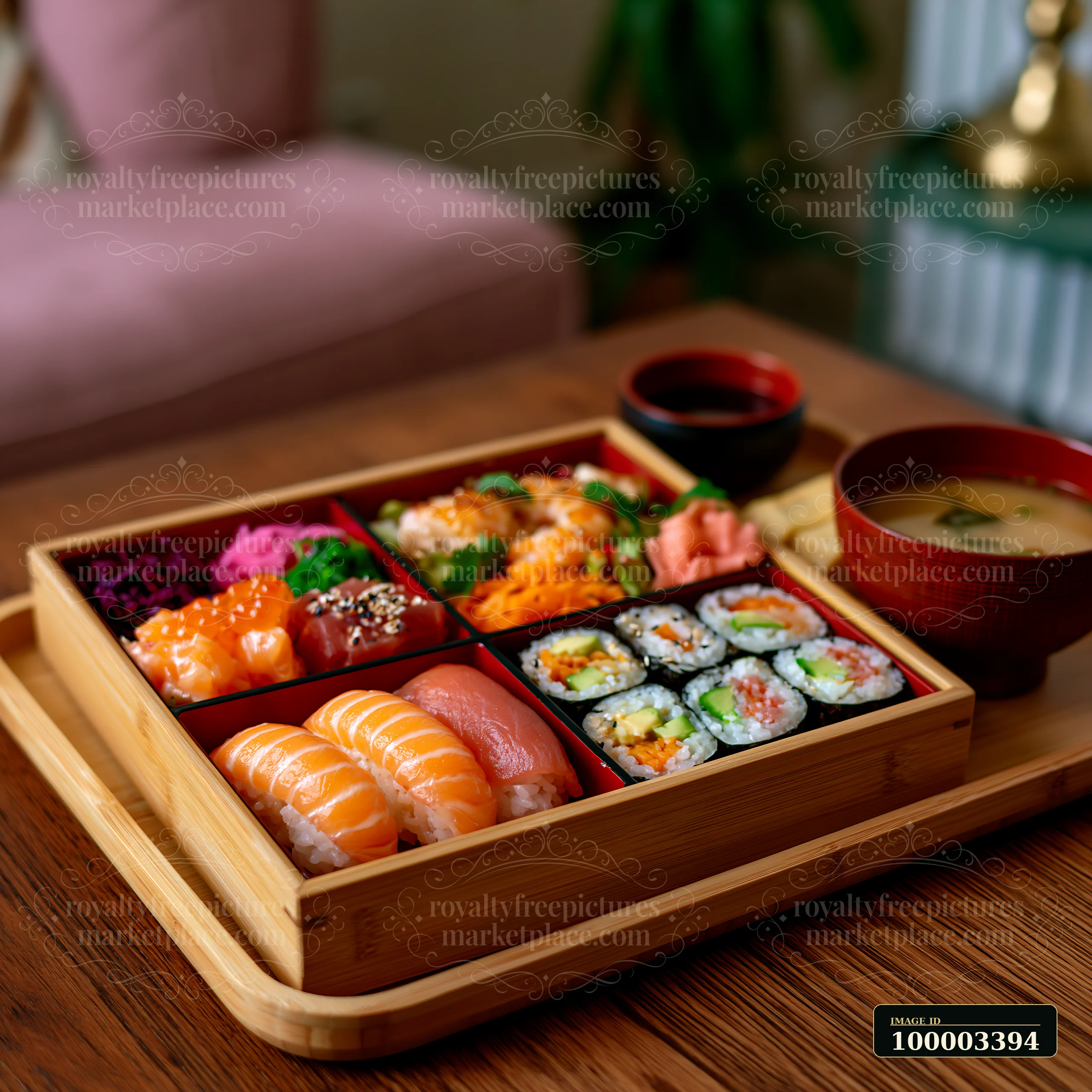 Sushi lunch box with compartments shows a wooden tray holding different sushi types, accompanied by dipping sauce and miso soup.