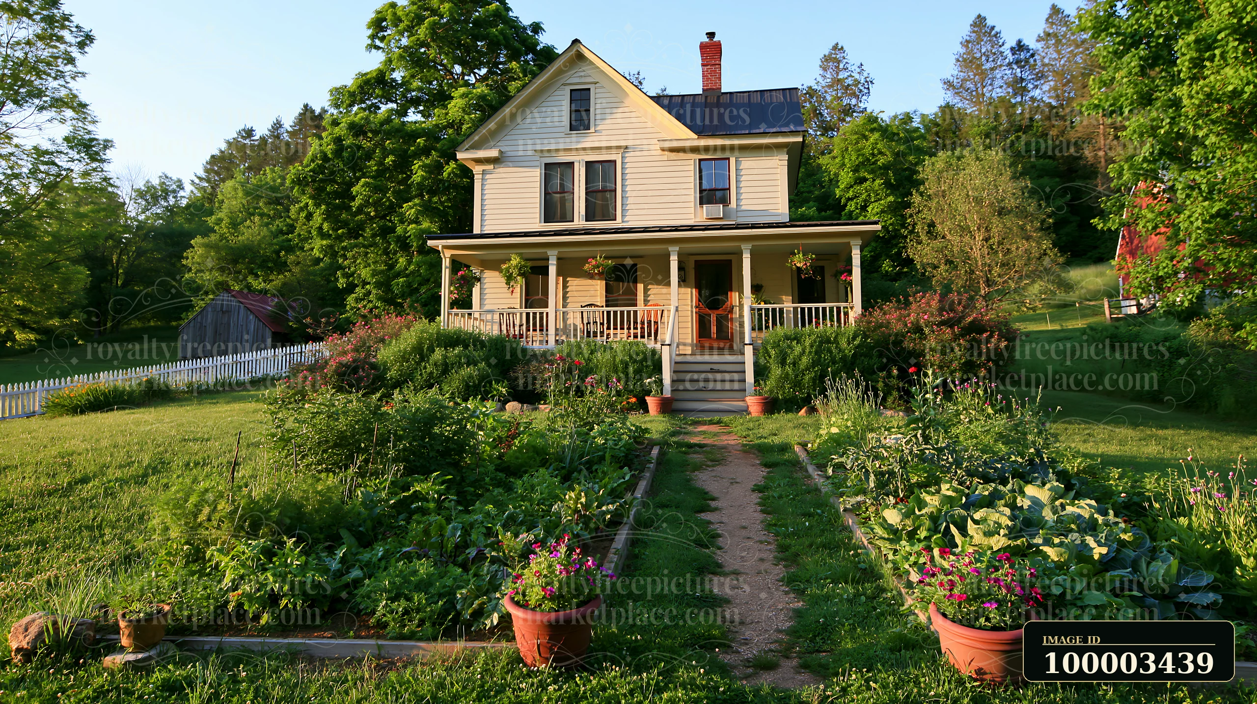 A restored farmhouse exterior features a welcoming porch surrounded by colorful flower pots and a manicured garden.