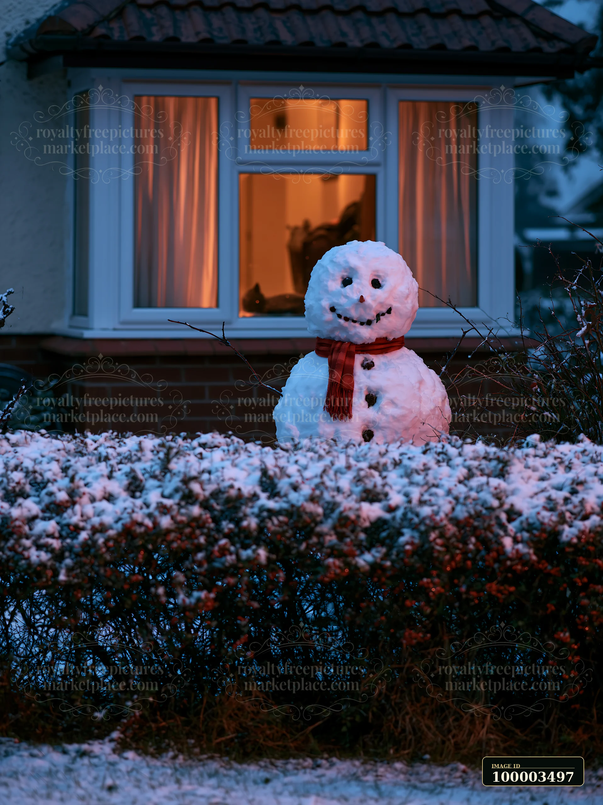 A snowman stands outside a cottage window during dusk.