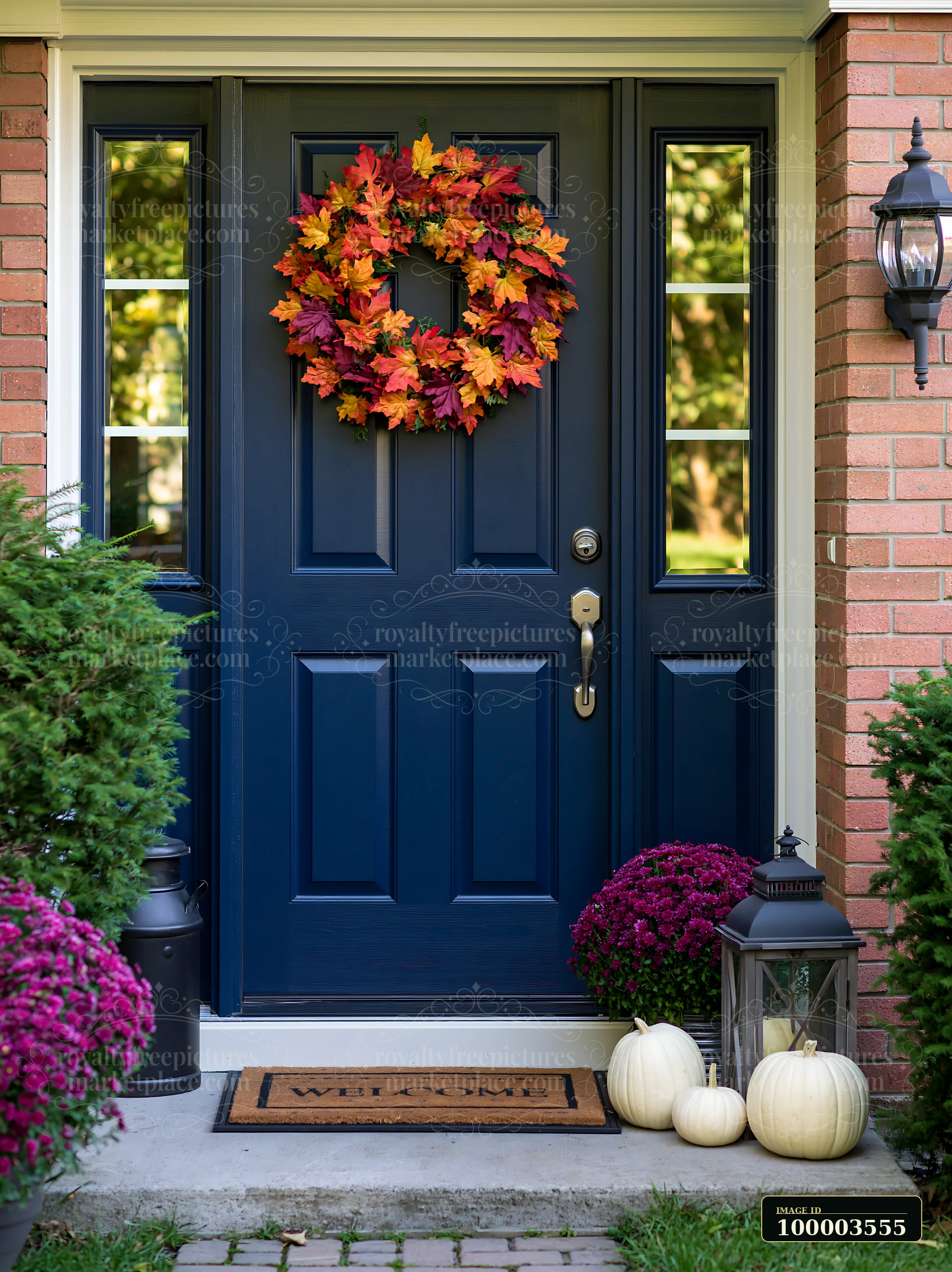 A blue front door is decorated with a colorful wreath made of leaves.