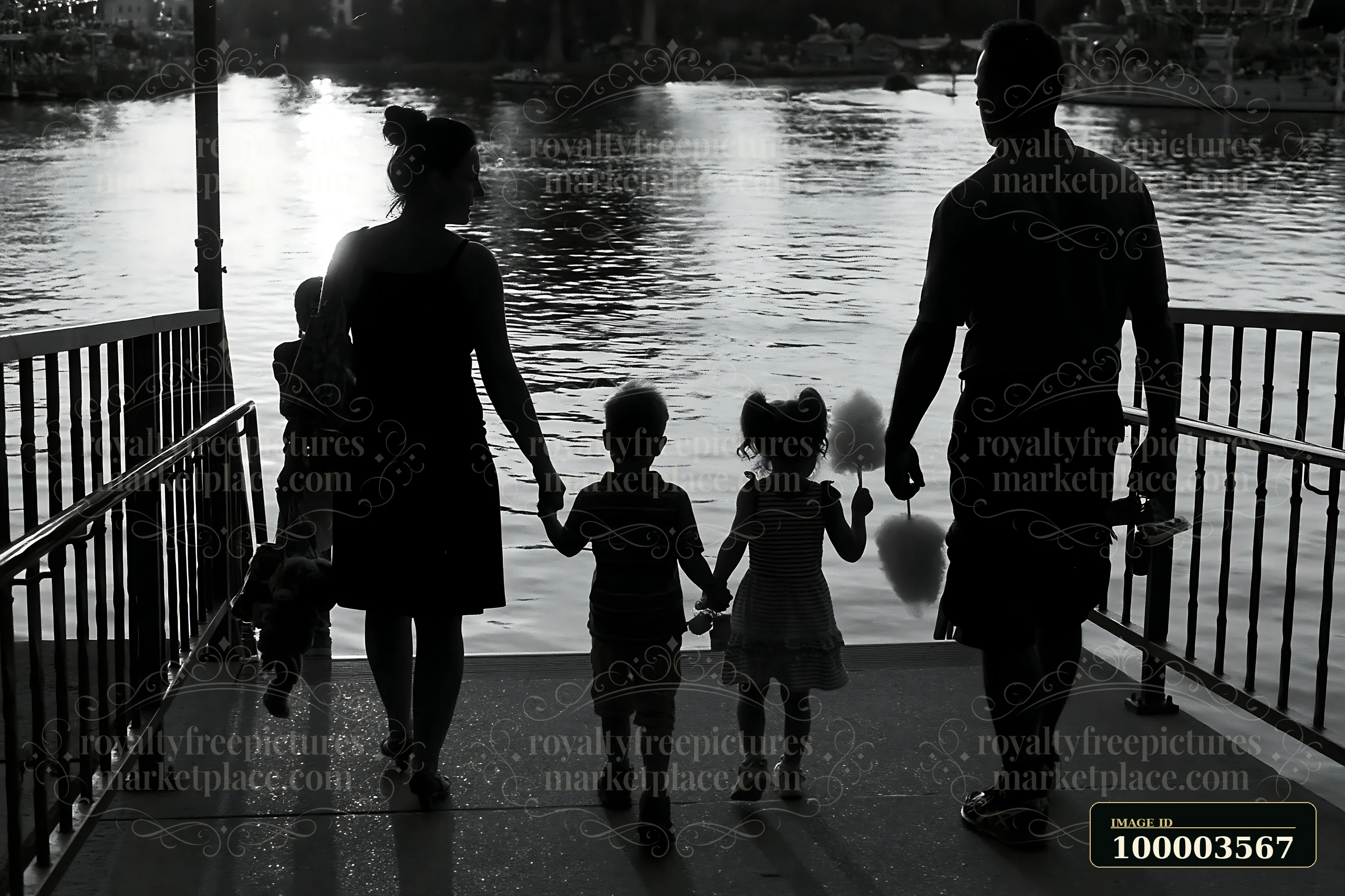 A family is leaving the kirmes with prizes, holding hands and walking by the water.