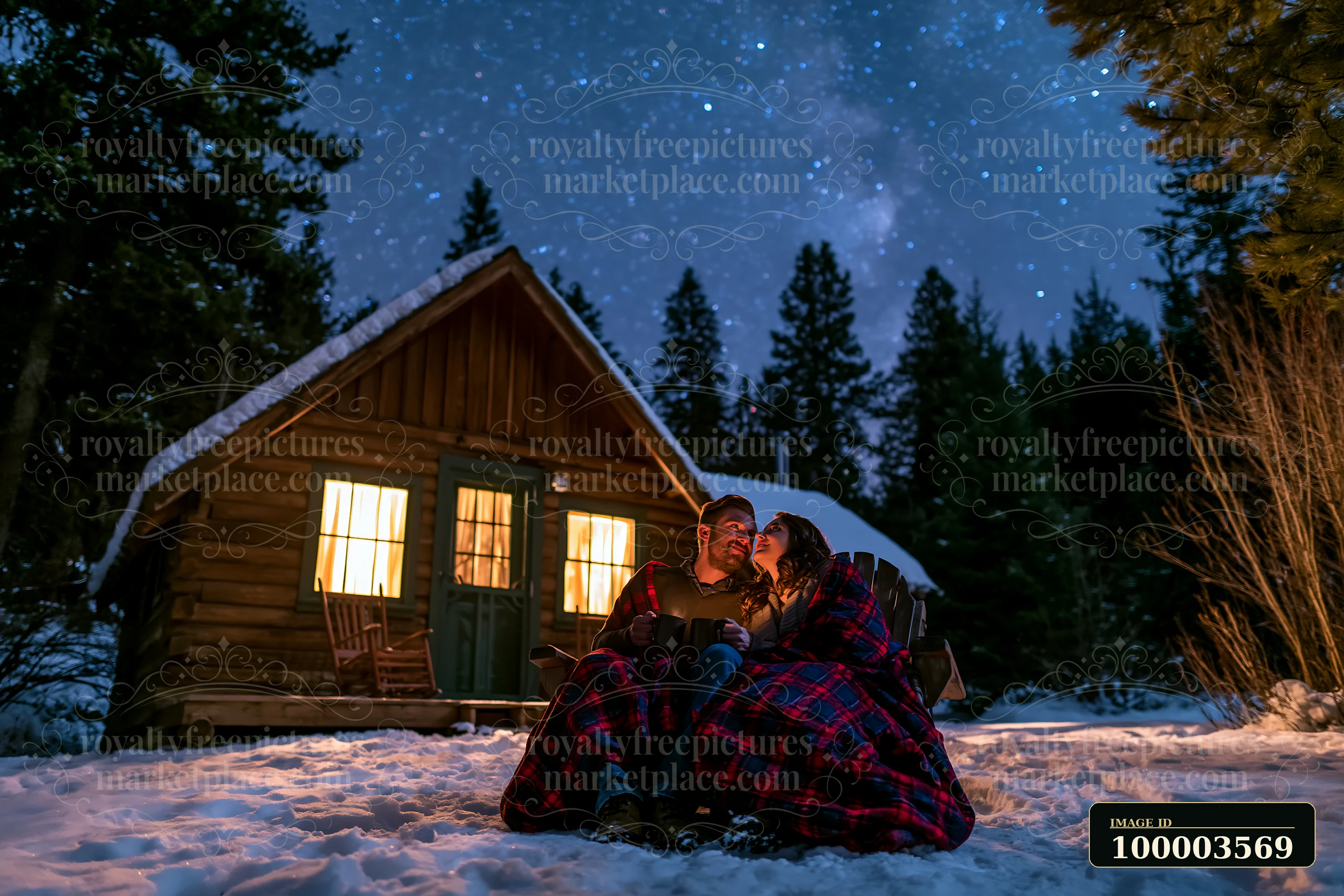 A couple sharing hot drinks under stars sits outside a cabin surrounded by snow.