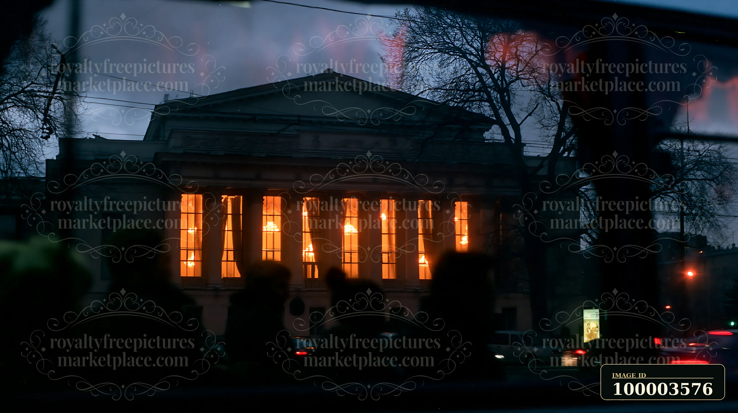 A view of the Soviet theater exterior shows glowing windows reflecting city lights and silhouettes of passerby in the foreground.