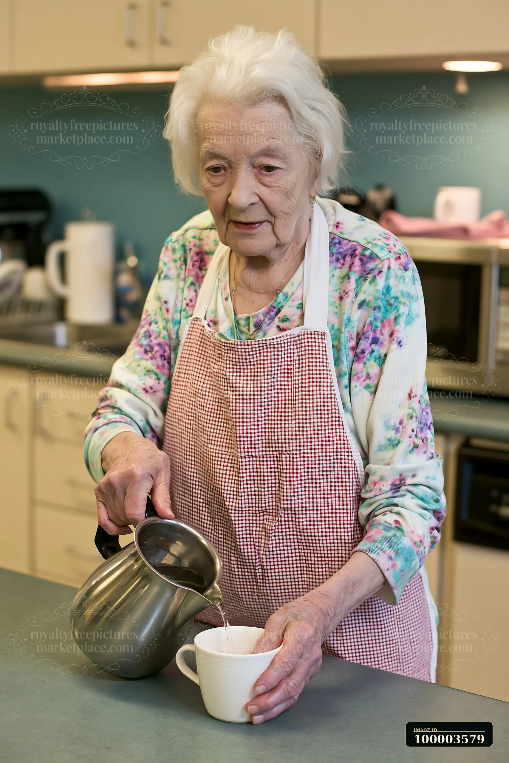 An older adult with Parkinson's attending occupational therapy is pouring tea into a cup in a kitchen.