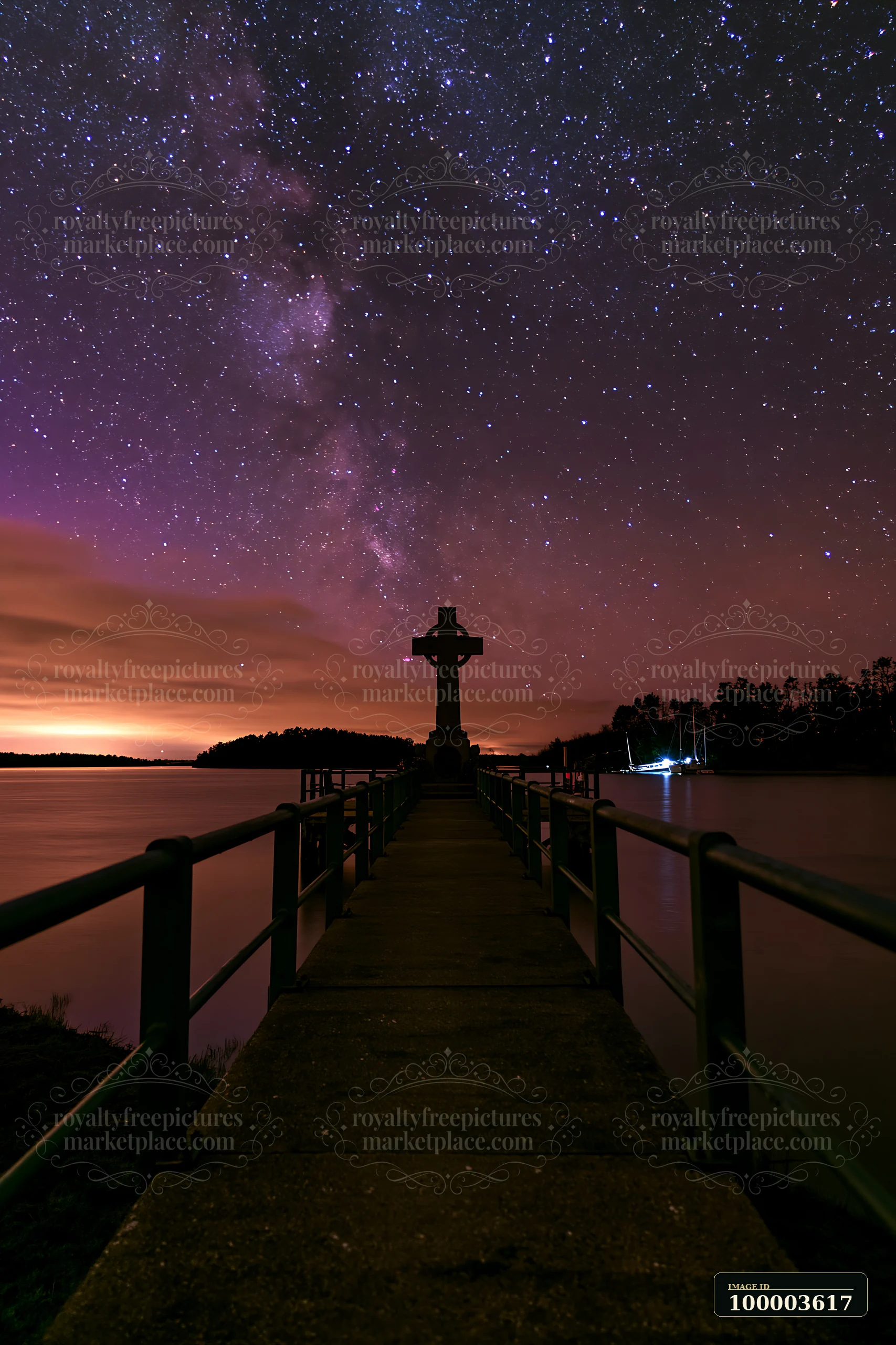 A war memorial cross is visible on a pier, silhouetted against a starry night sky.