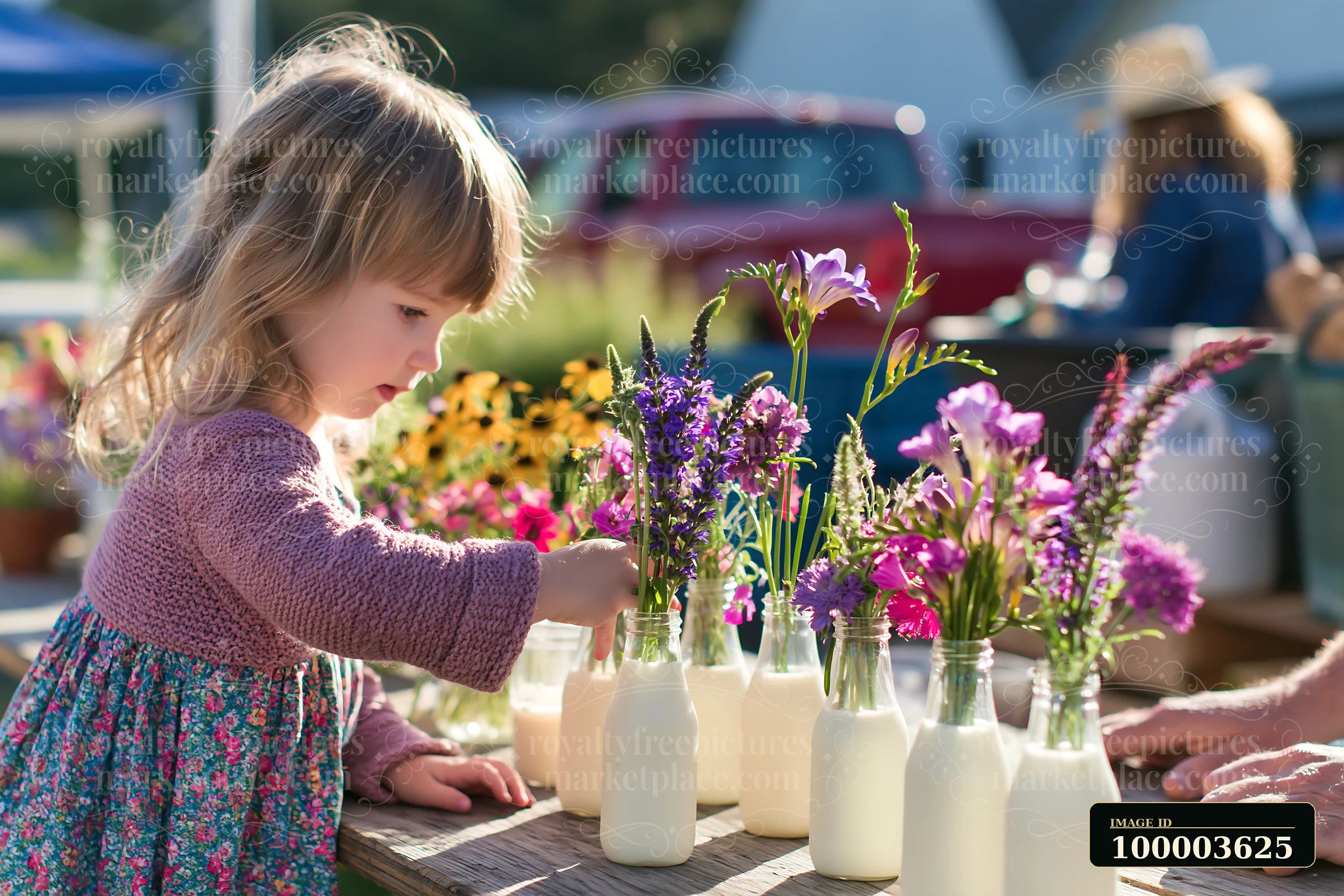 A young girl adjusts flowers in milk bottles while at a market table surrounded by colorful blooms.