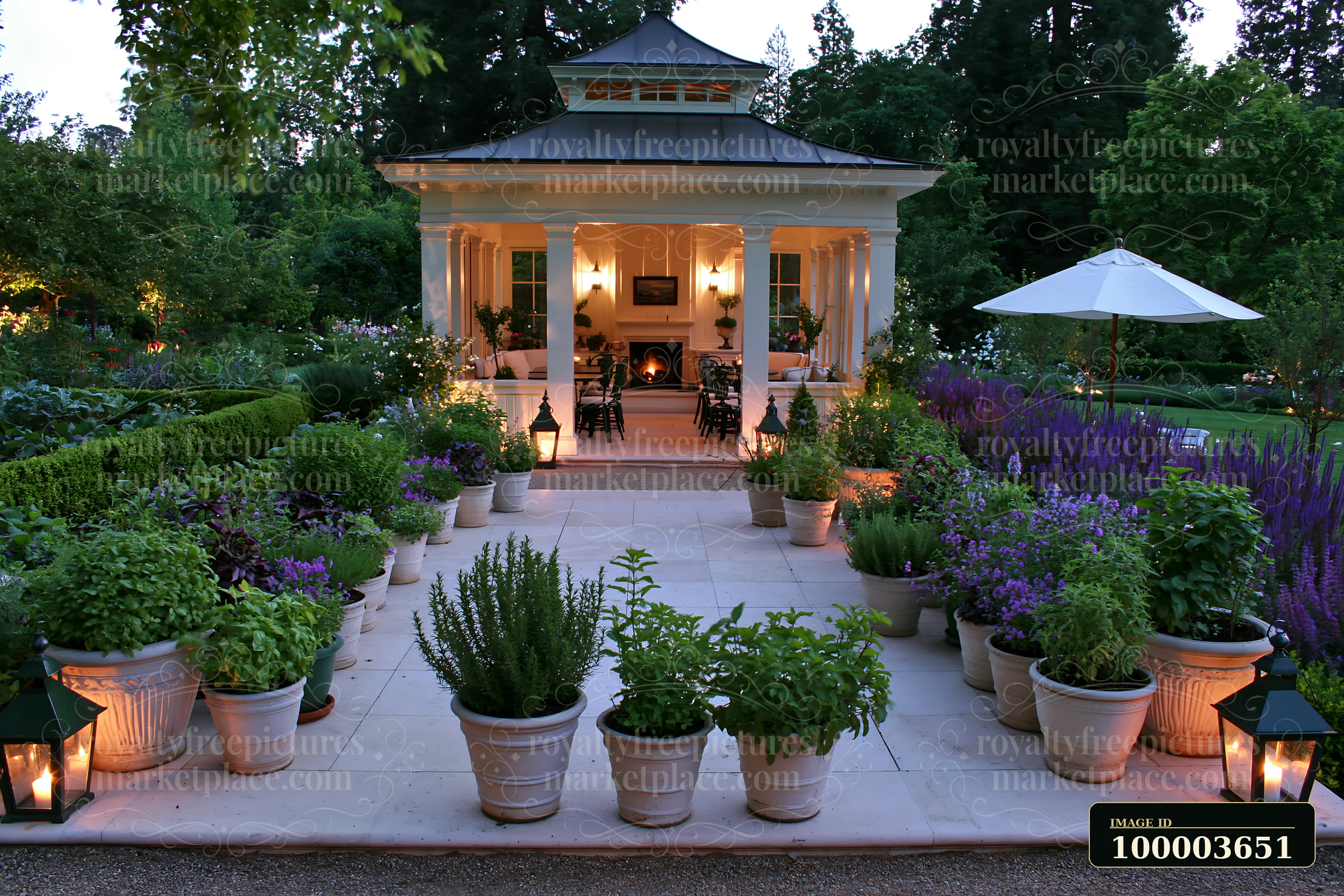 Illuminated garden pavilion surrounded by flowers, potted plants, lanterns, and a white umbrella at evening.