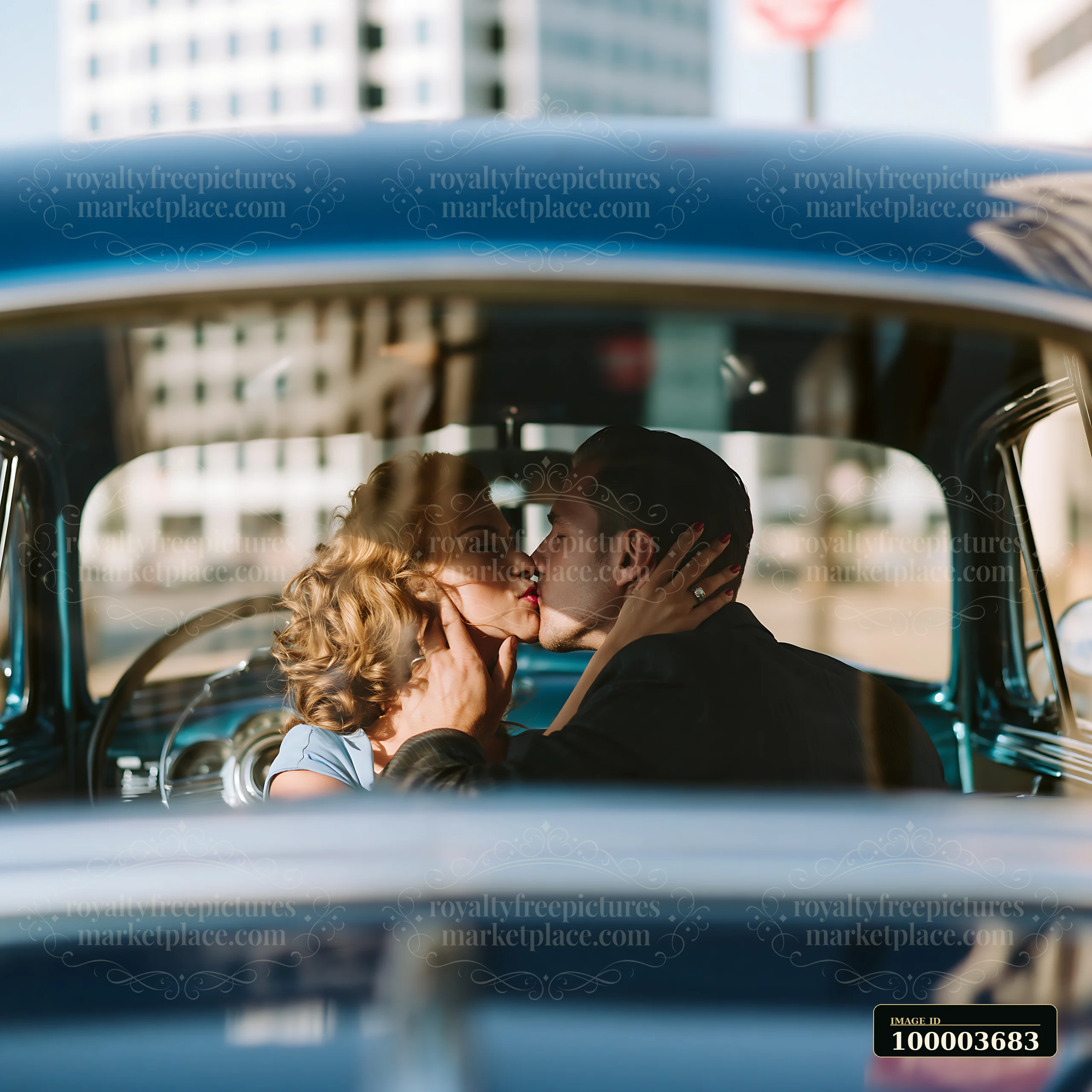 A couple is kissing in a vintage car parked on a city street.