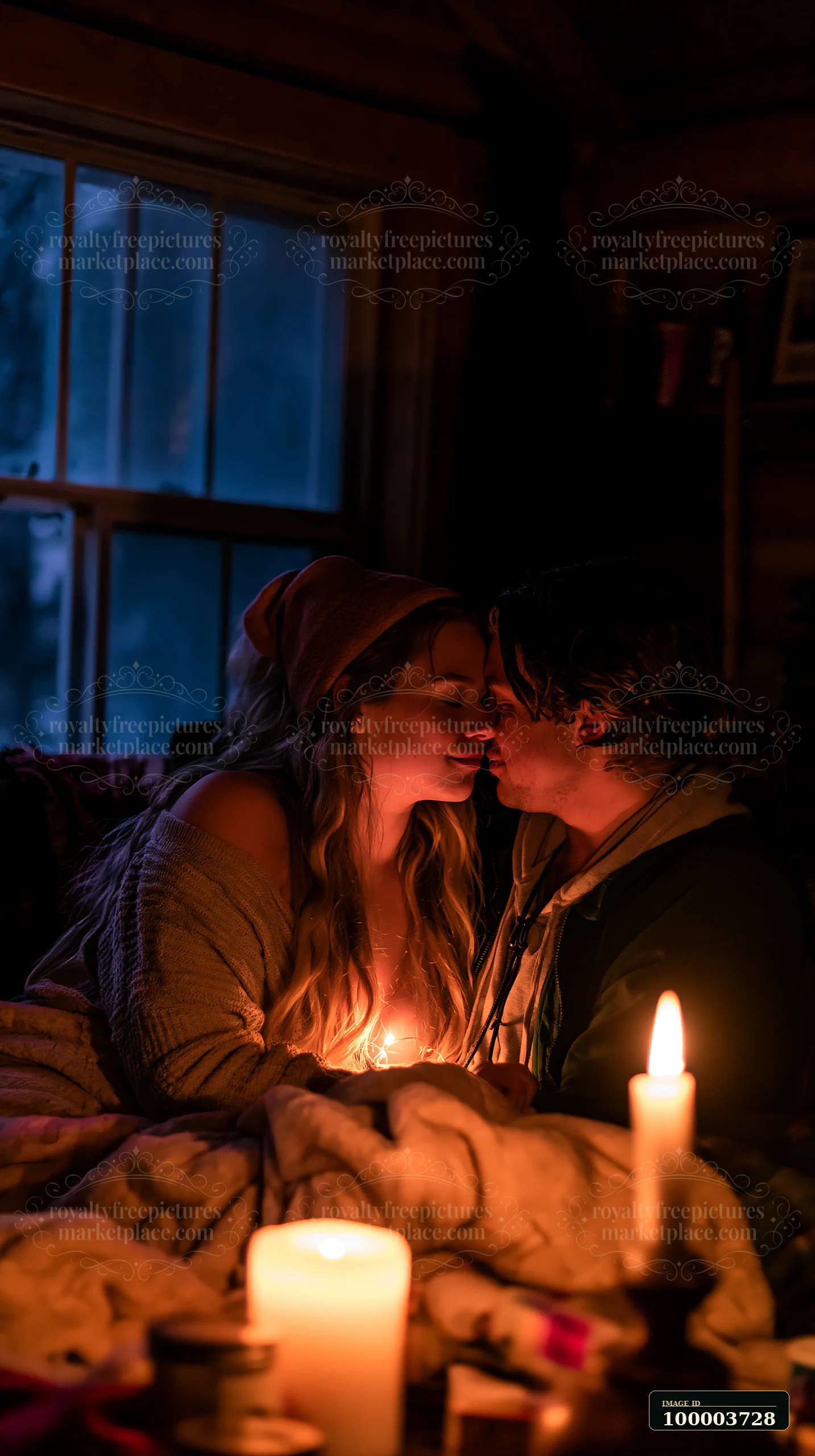 A couple sits close together in a cabin, sharing an intimate moment with a gentle kiss on the forehead.