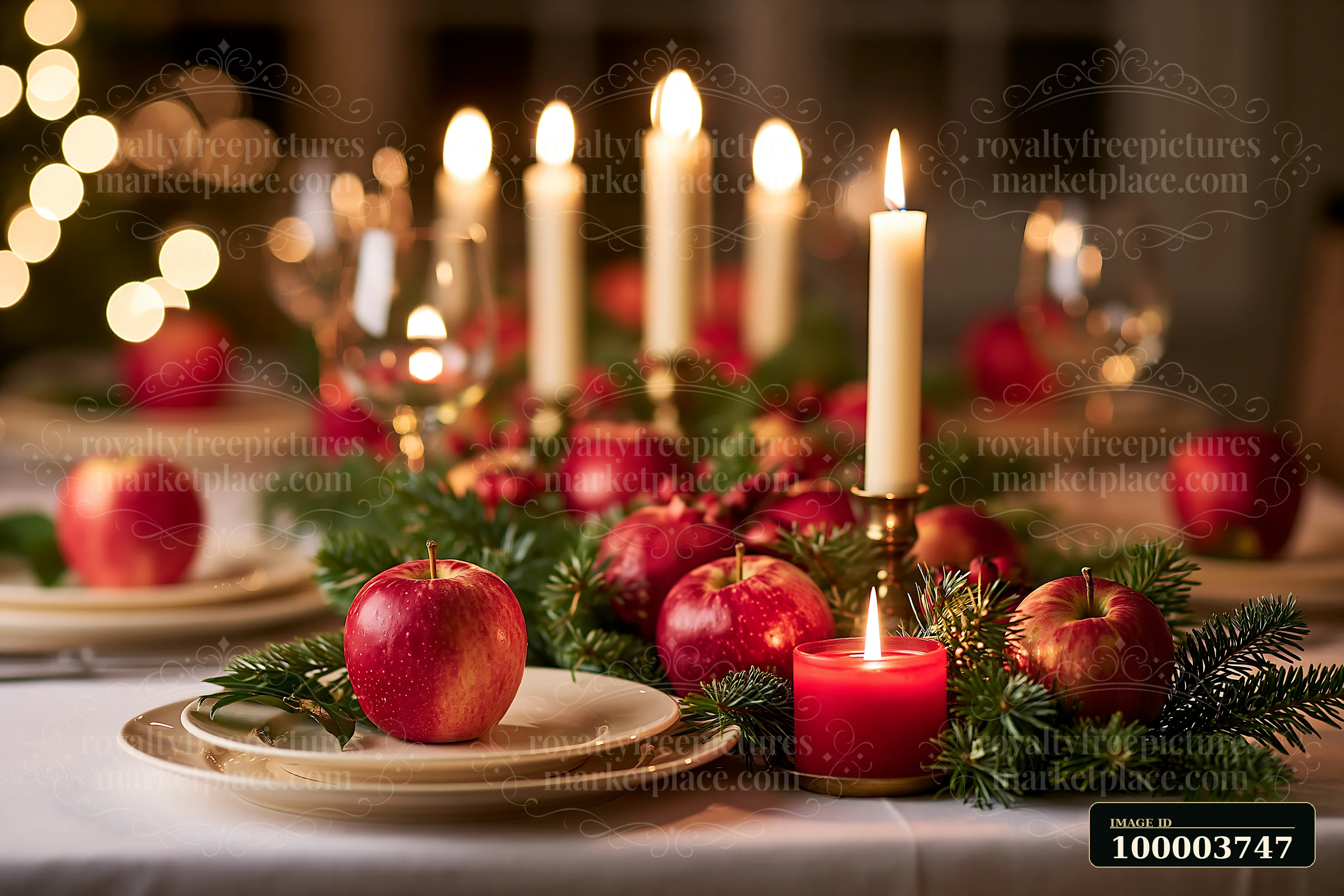 Christmas table centerpiece with red apples, evergreen branches, glowing candles, and open copy space.