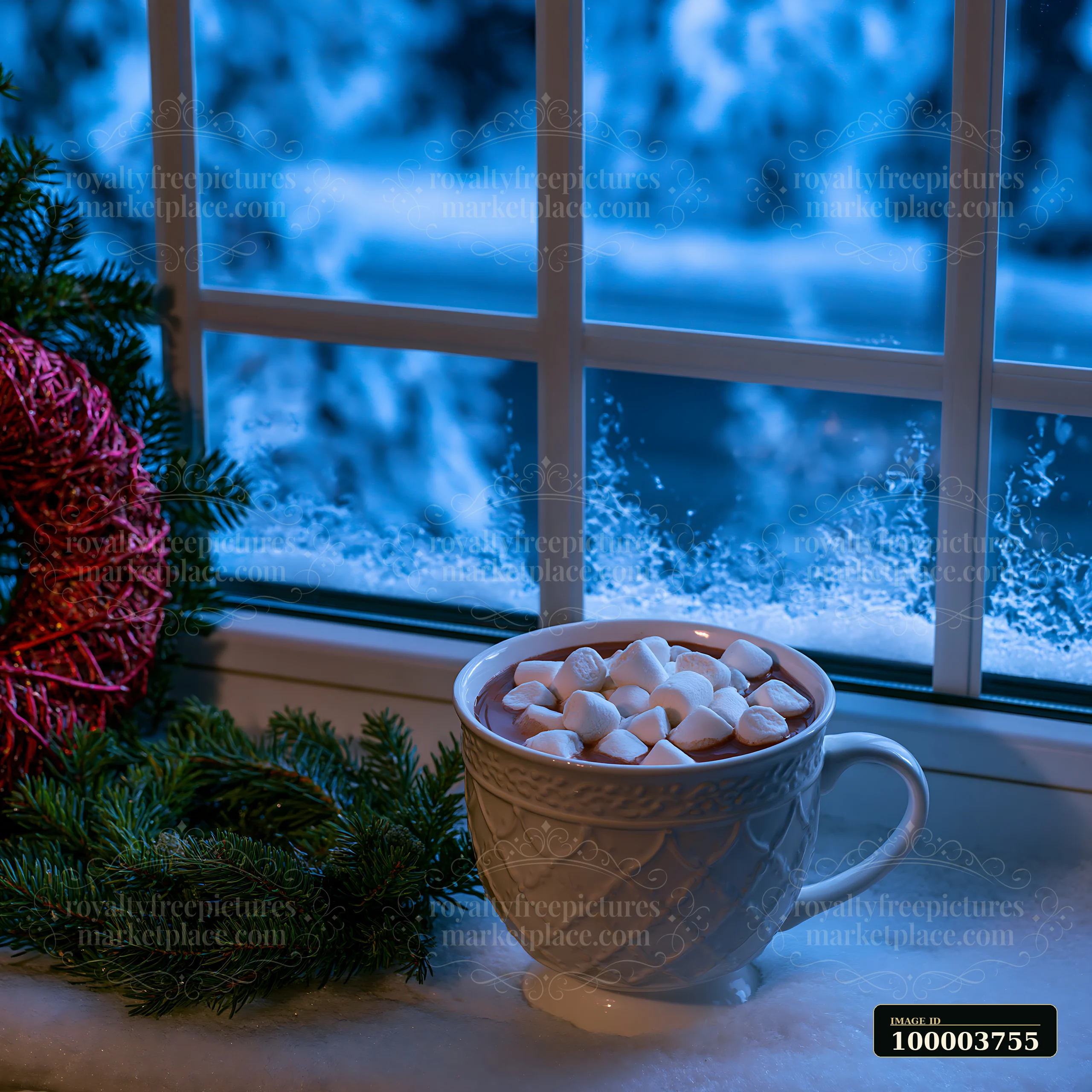 A cup of warm cocoa topped with marshmallows sits near a window showing falling snow.
