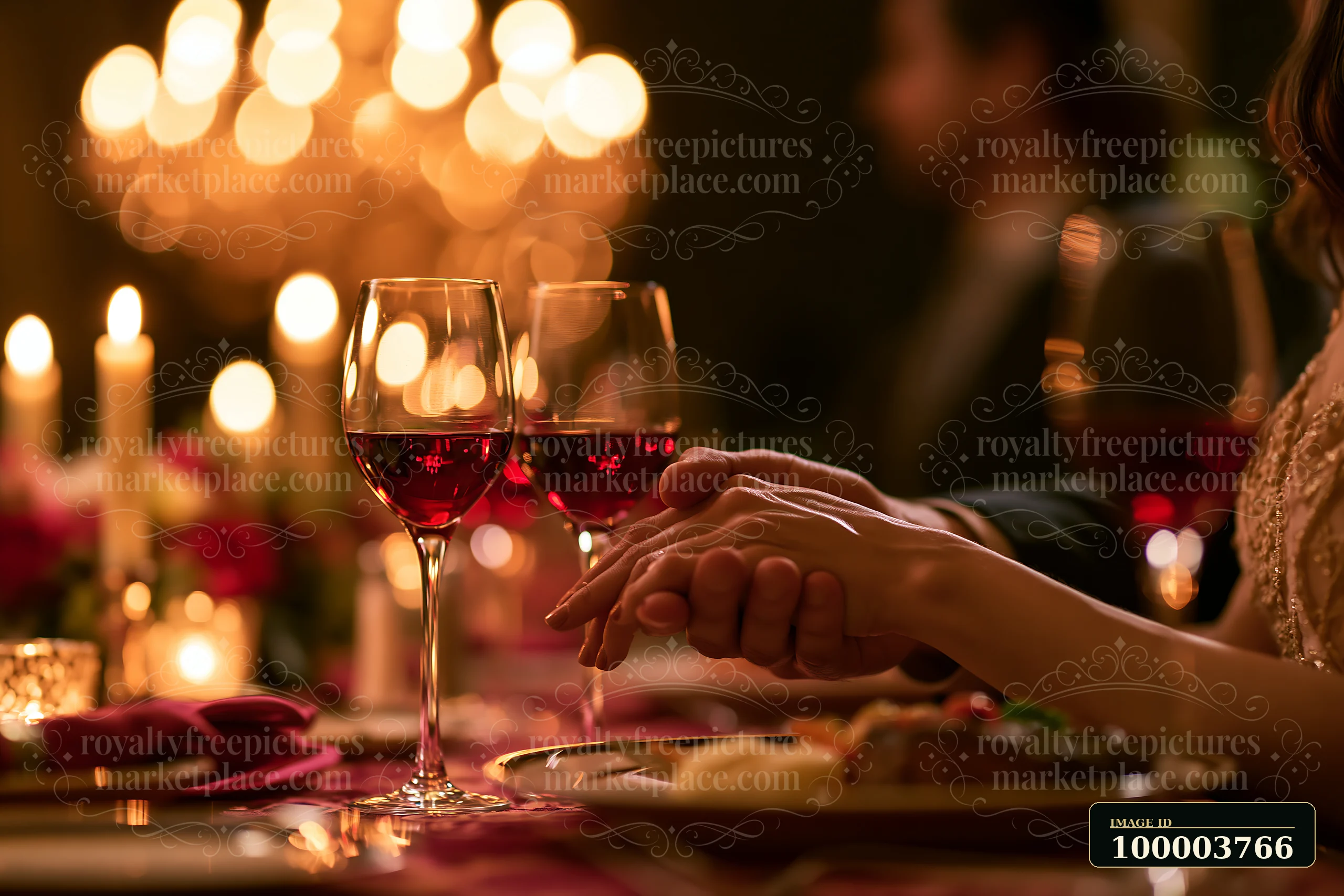 A man kisses a woman's hand across a candlelit dinner table with wine glasses and warm romantic lighting.