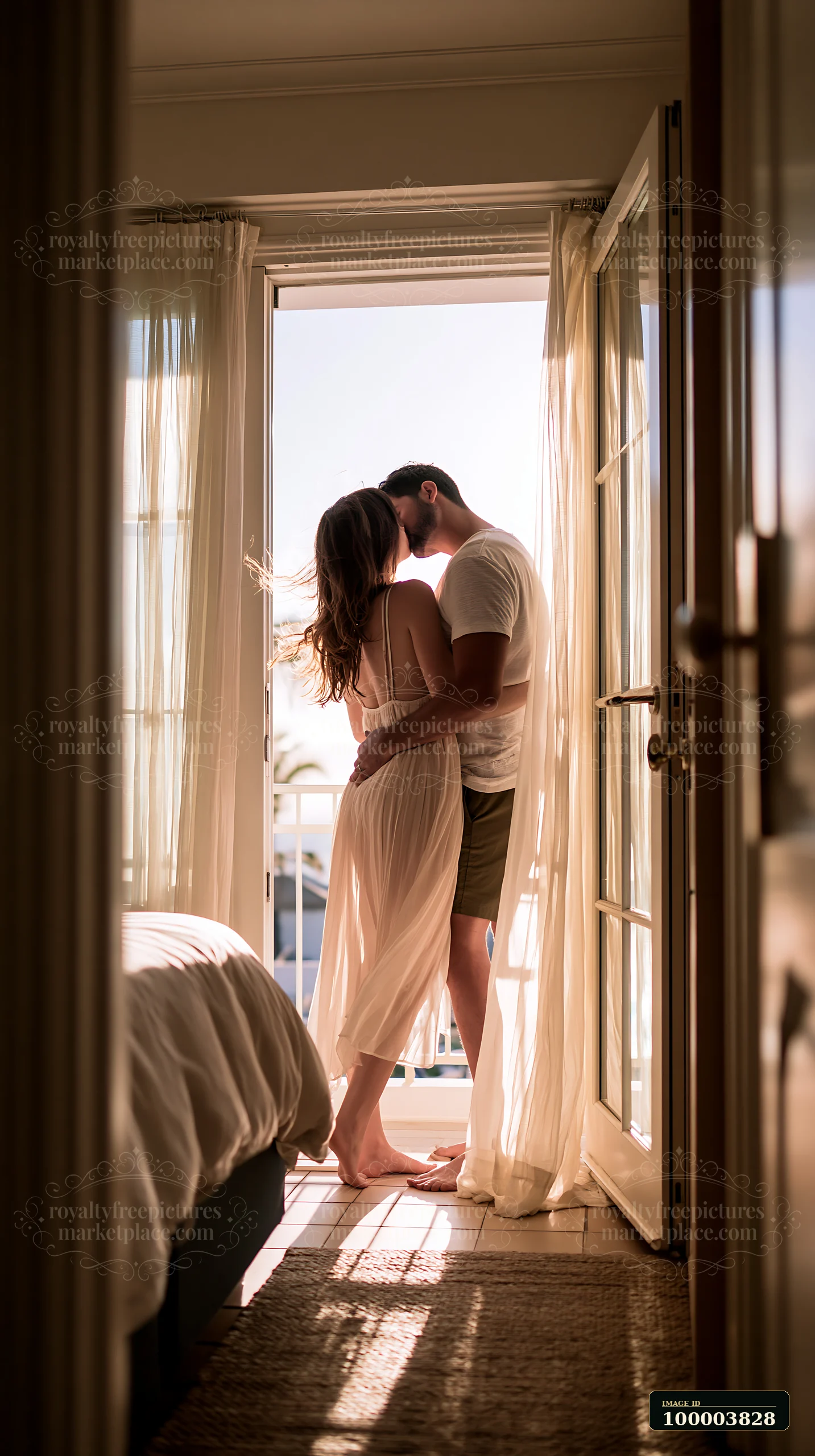 A couple kisses in a bright bedroom with open doors, warm sunlight illuminating the space.