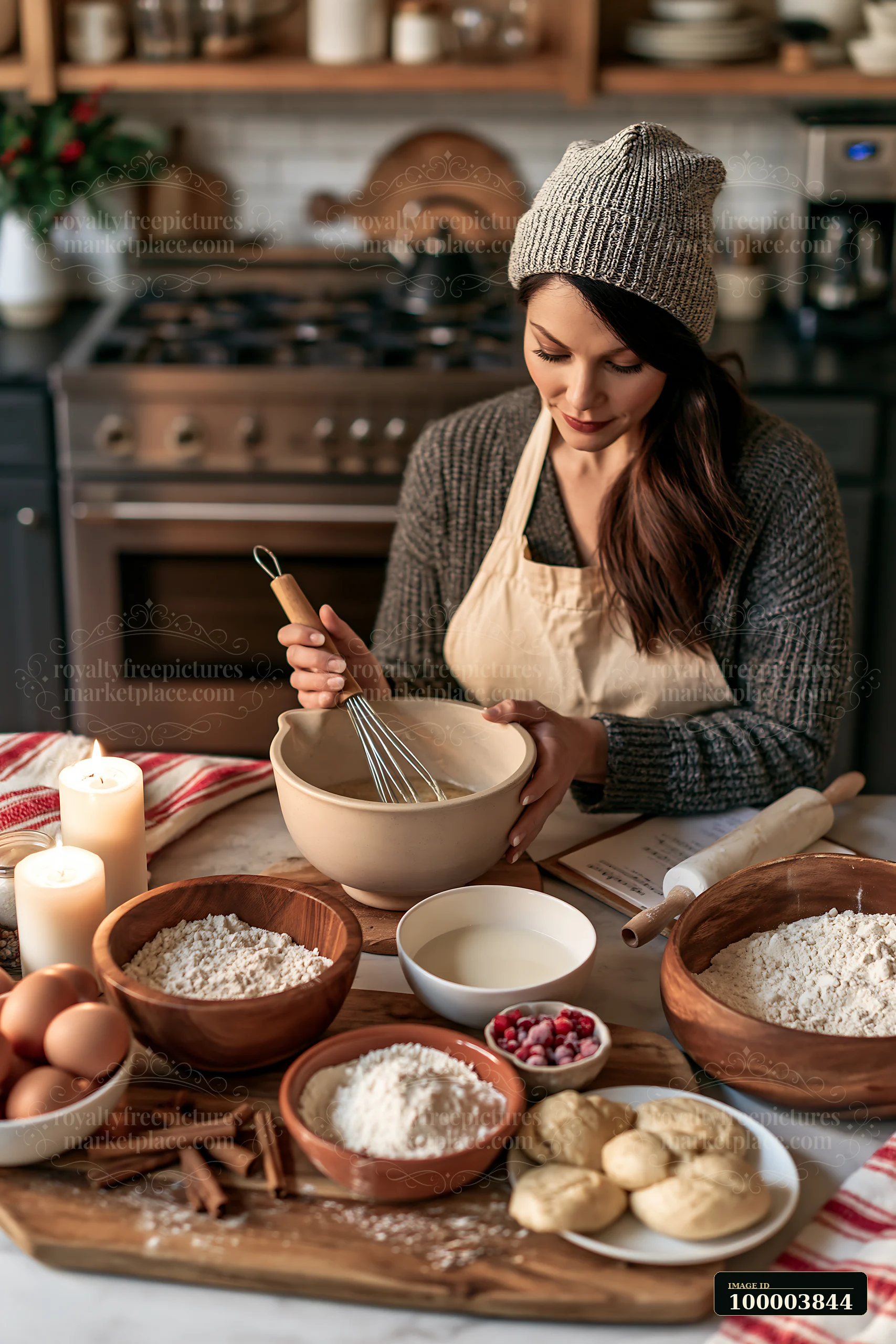 A woman stirs a bowl of holiday baking ingredients on a kitchen countertop.