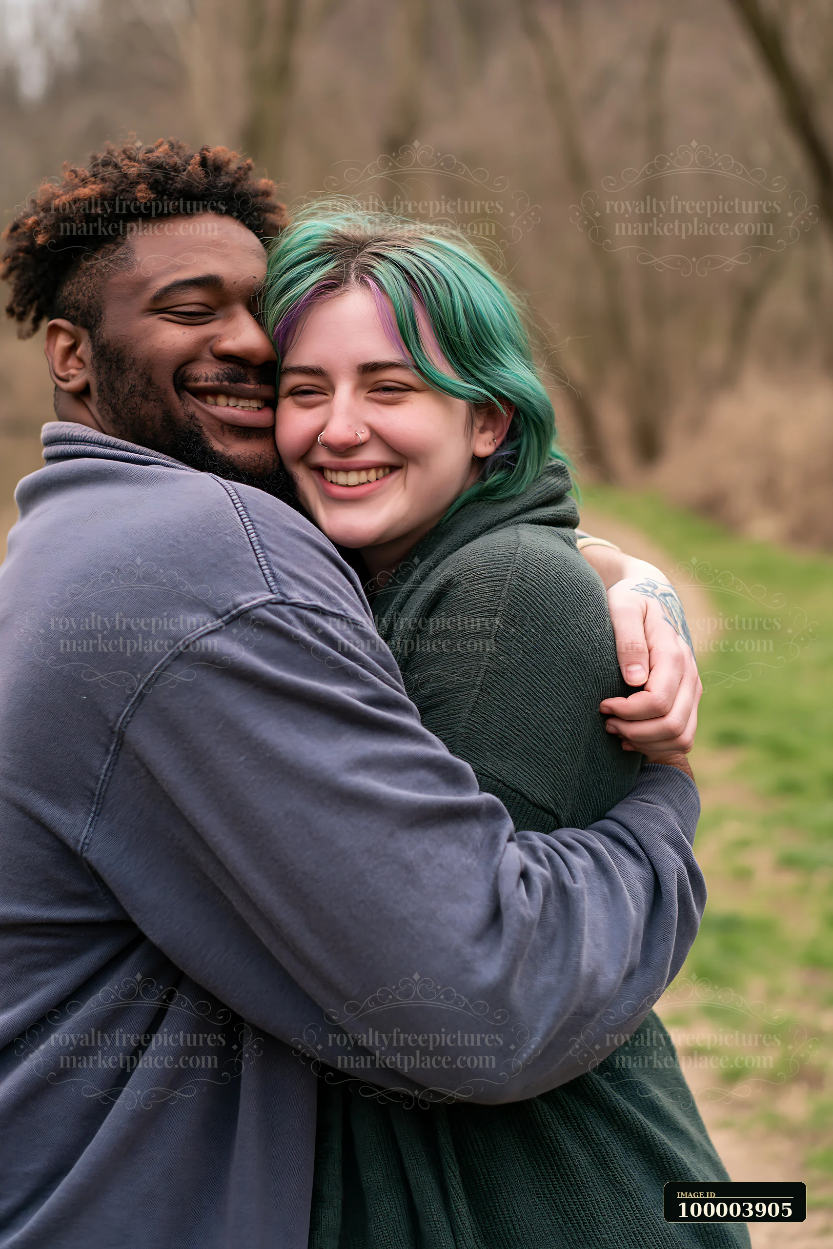 Smiling couple embraces outdoors in spring with trees and soft greenery behind them.