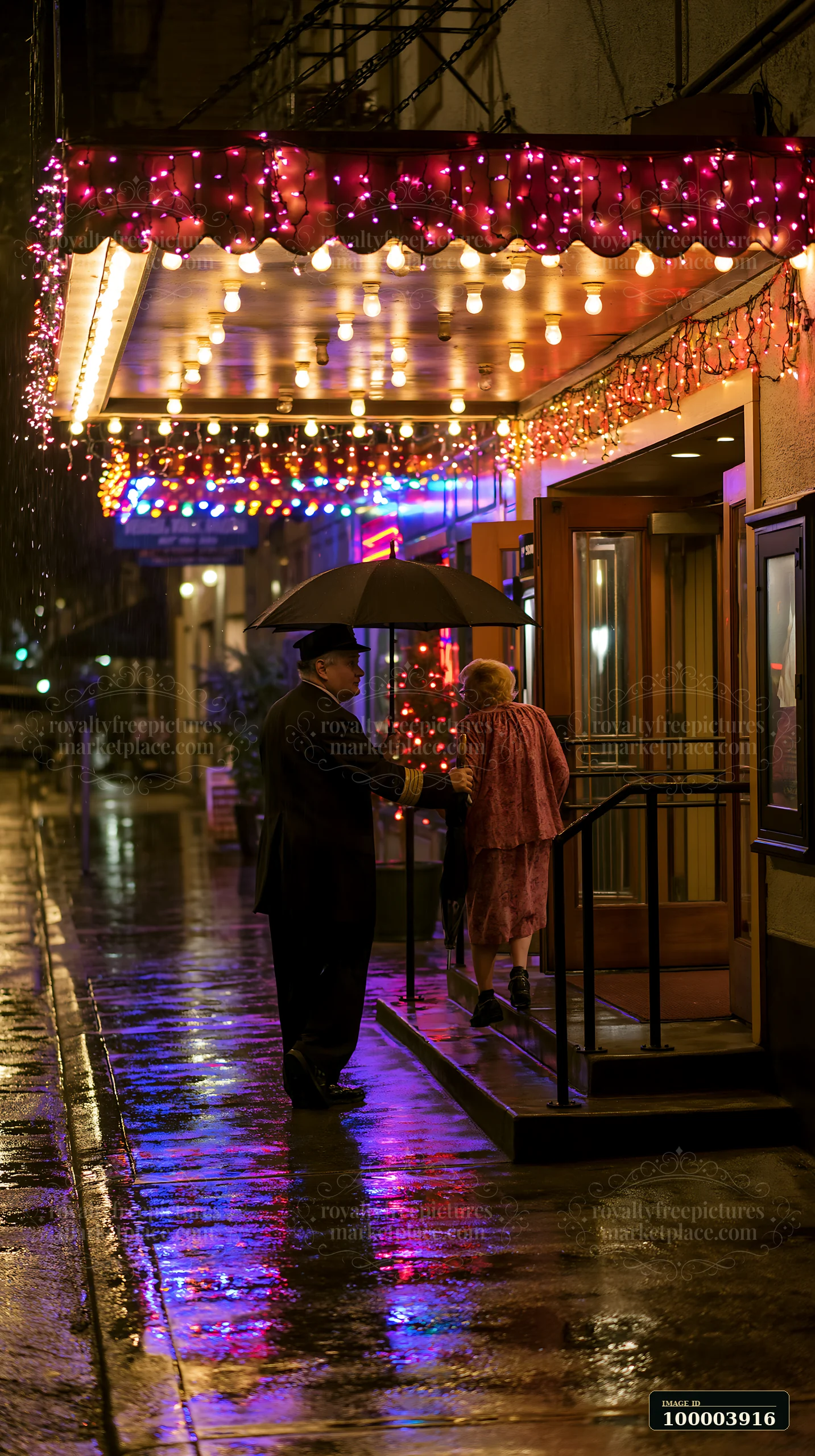 Two people walk beneath an umbrella past Christmas lights and colorful reflections on a wet pavement.