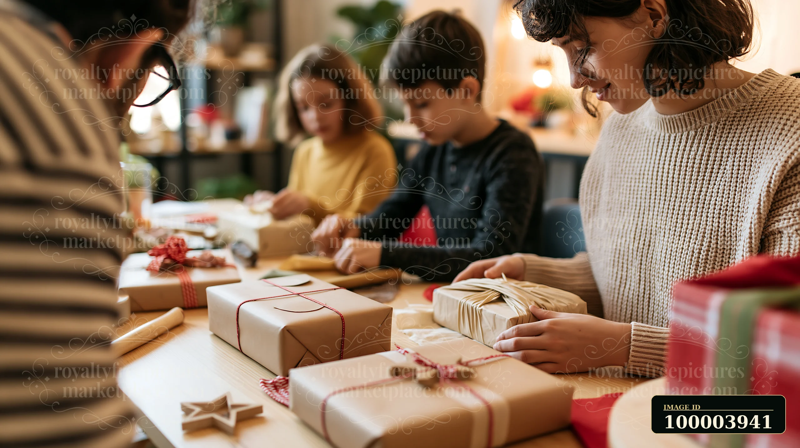 A family is gathered around a table in a cozy room, engaged in gift wrapping activities.