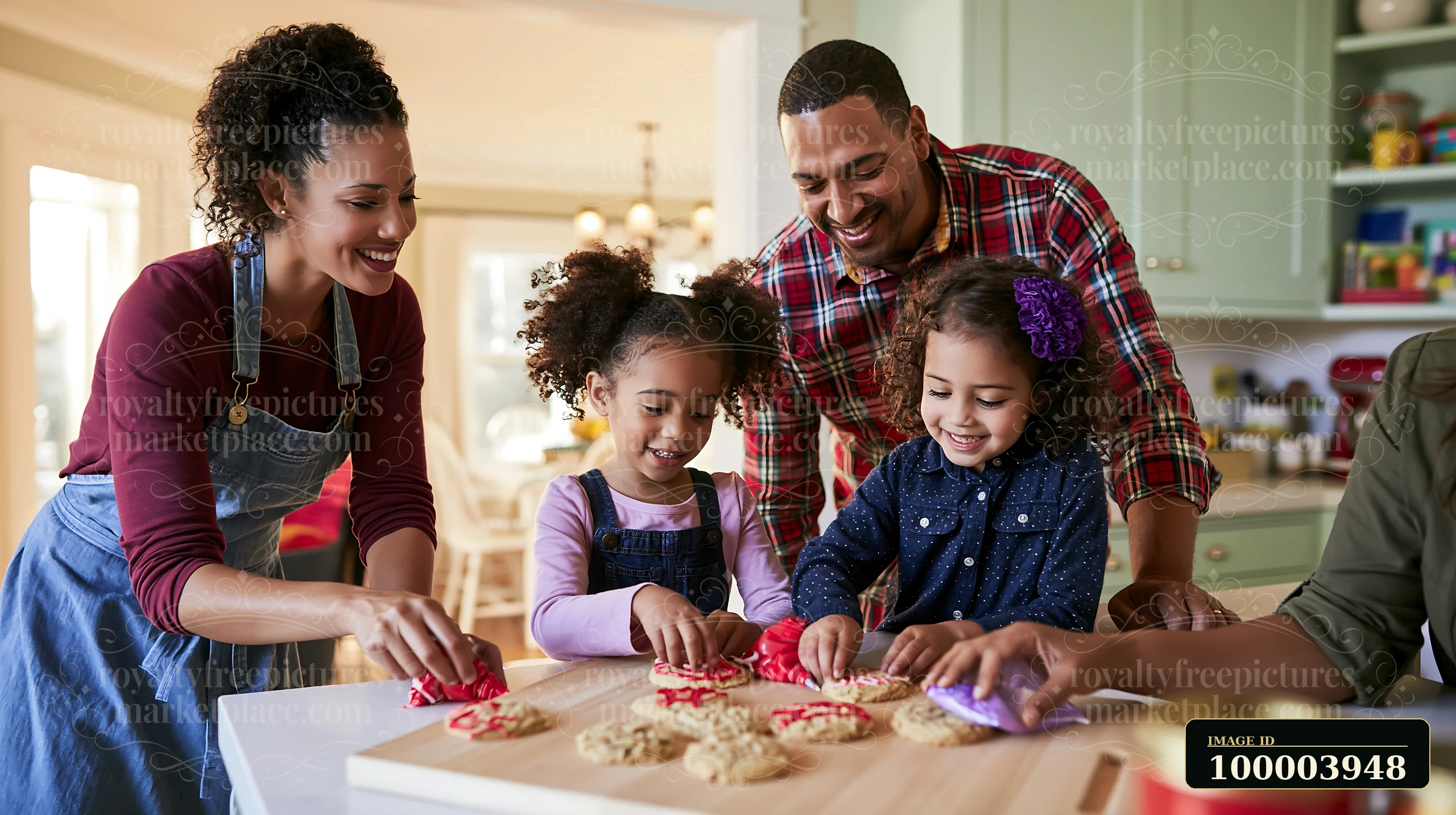 Two parents help their daughters decorate iced cookies at a kitchen counter.