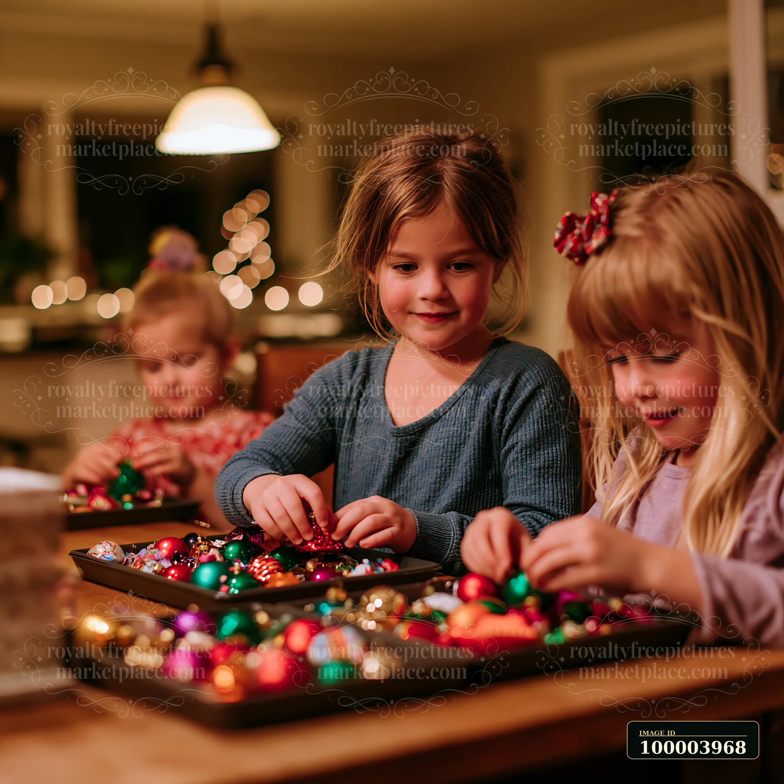 Three children are sorting colorful Christmas decorations on a wooden table in a cozy home setting.