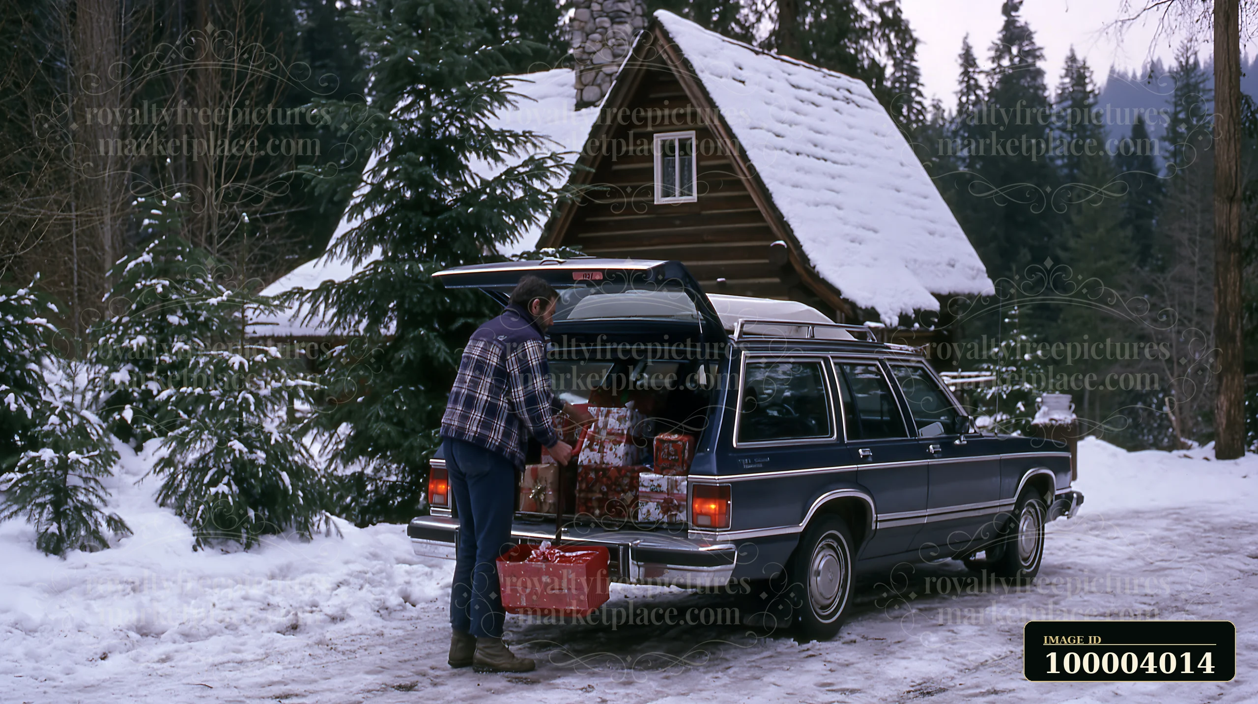 A person loads gifts into the back of a car parked near a snowy cabin.
