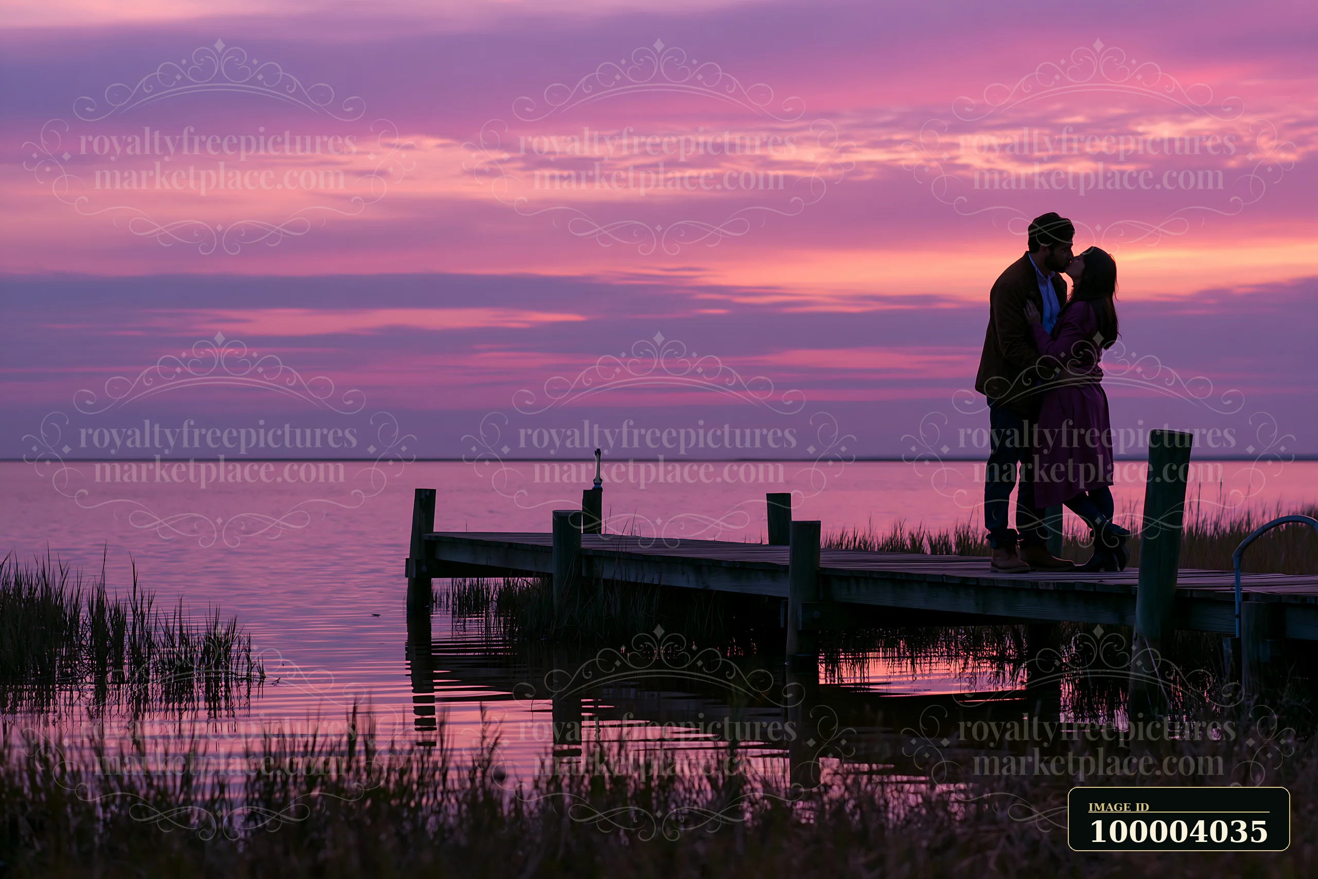 Couple kissing on a lakeside dock at sunset, with expansive pink and purple sky providing copy space.
