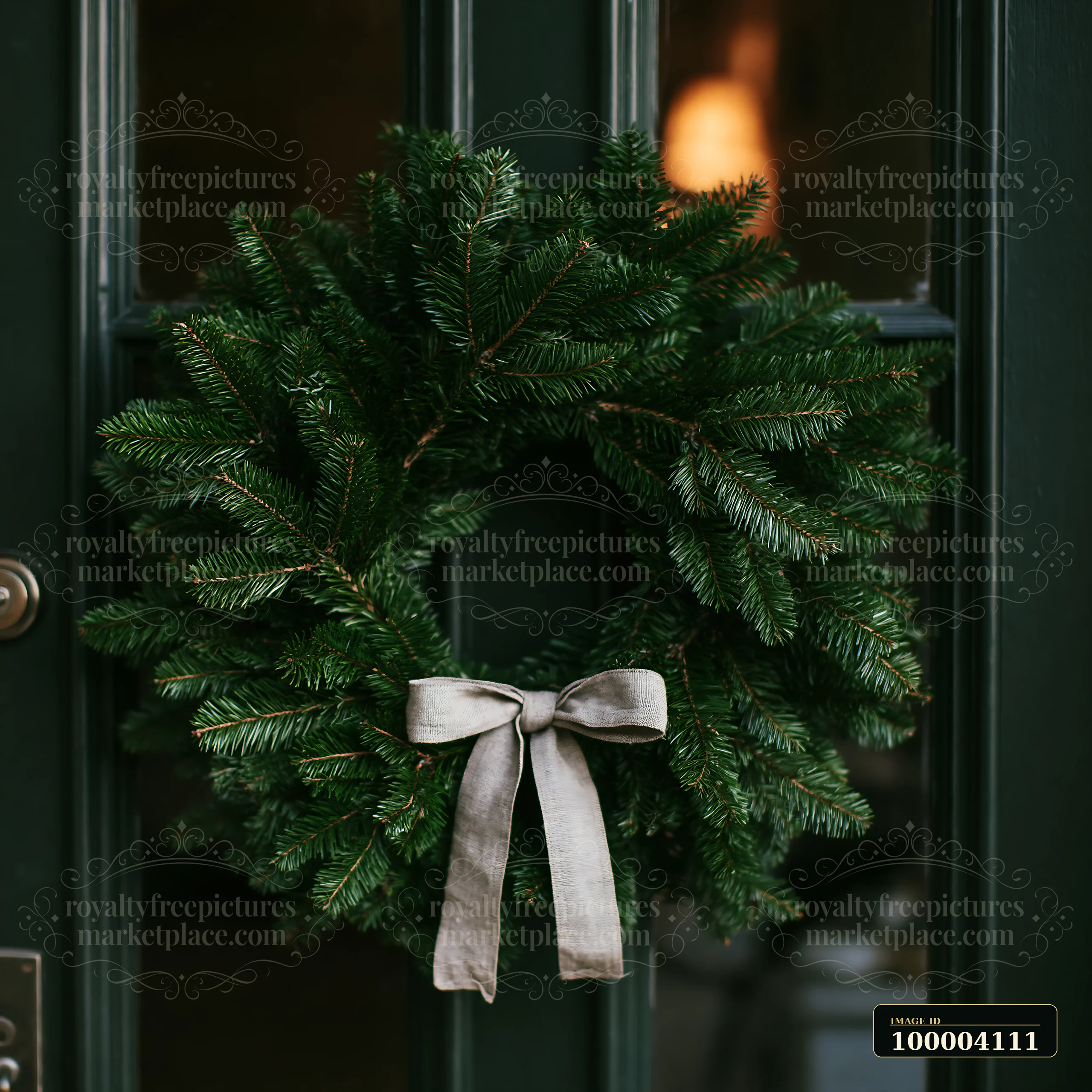 A round Christmas wreath hangs on a dark green apartment door.