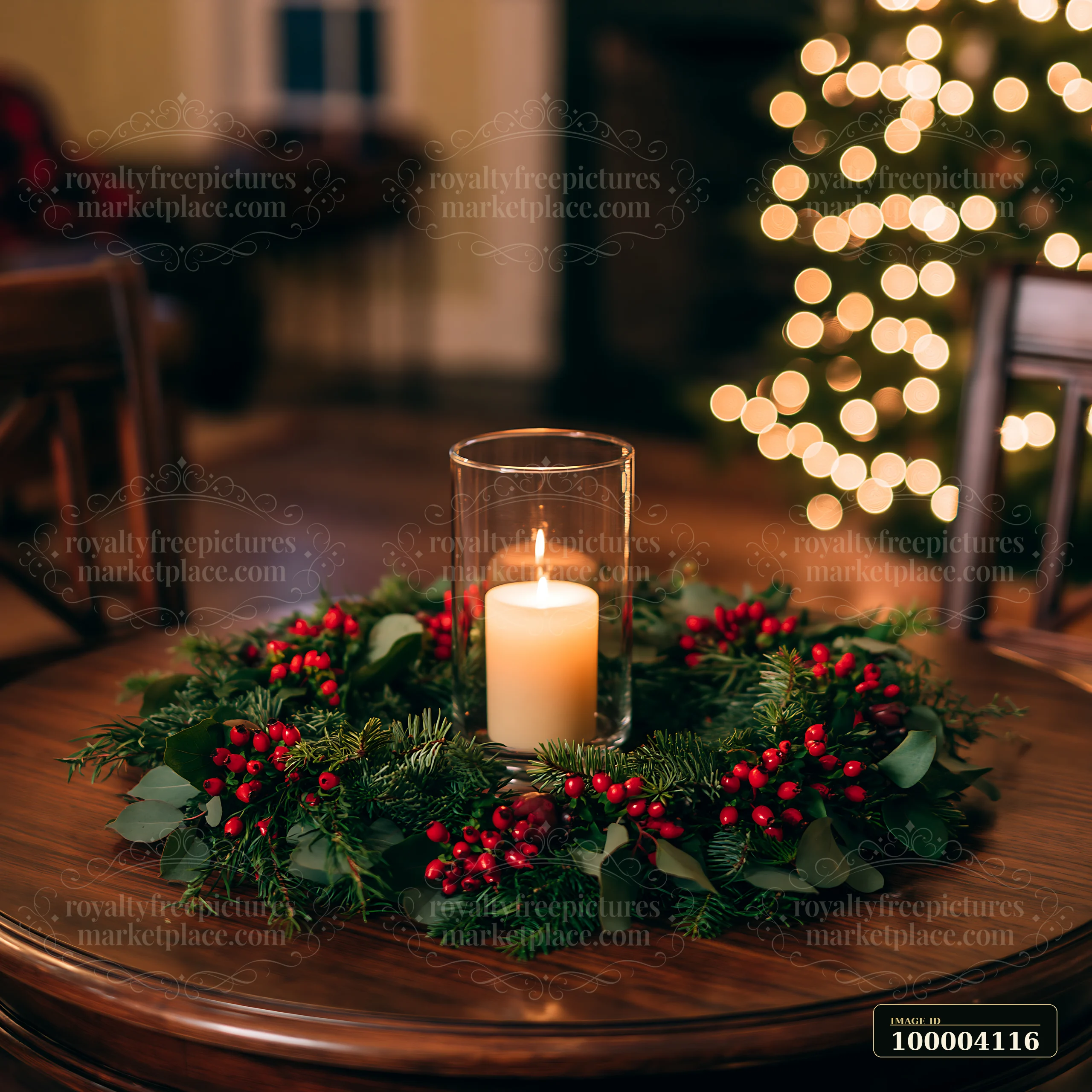Candle centerpiece with evergreen branches and red berries on a wooden table, with blurred Christmas lights behind it.