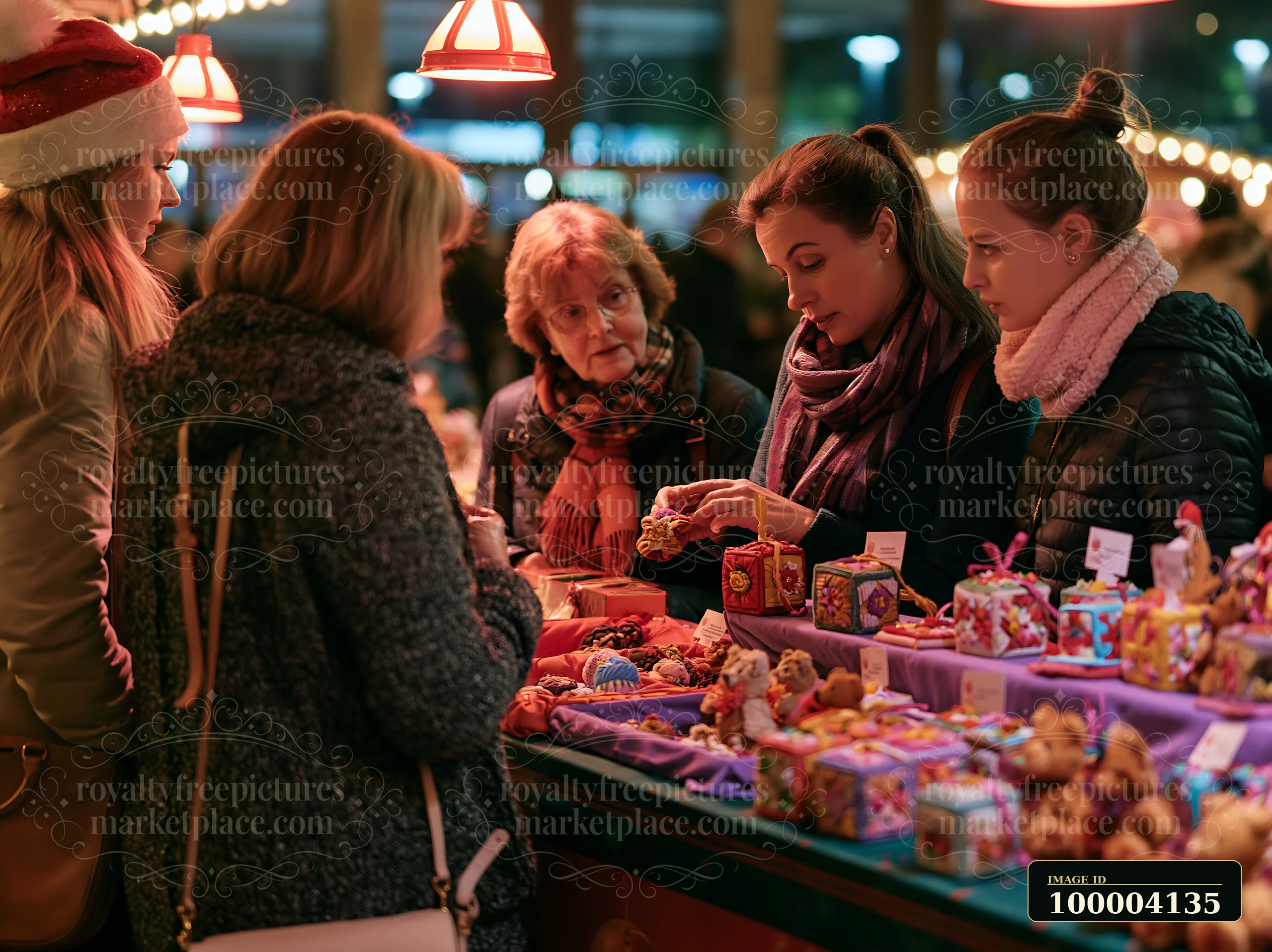 Shoppers gather around a market stall filled with handmade ornaments during a festive event.