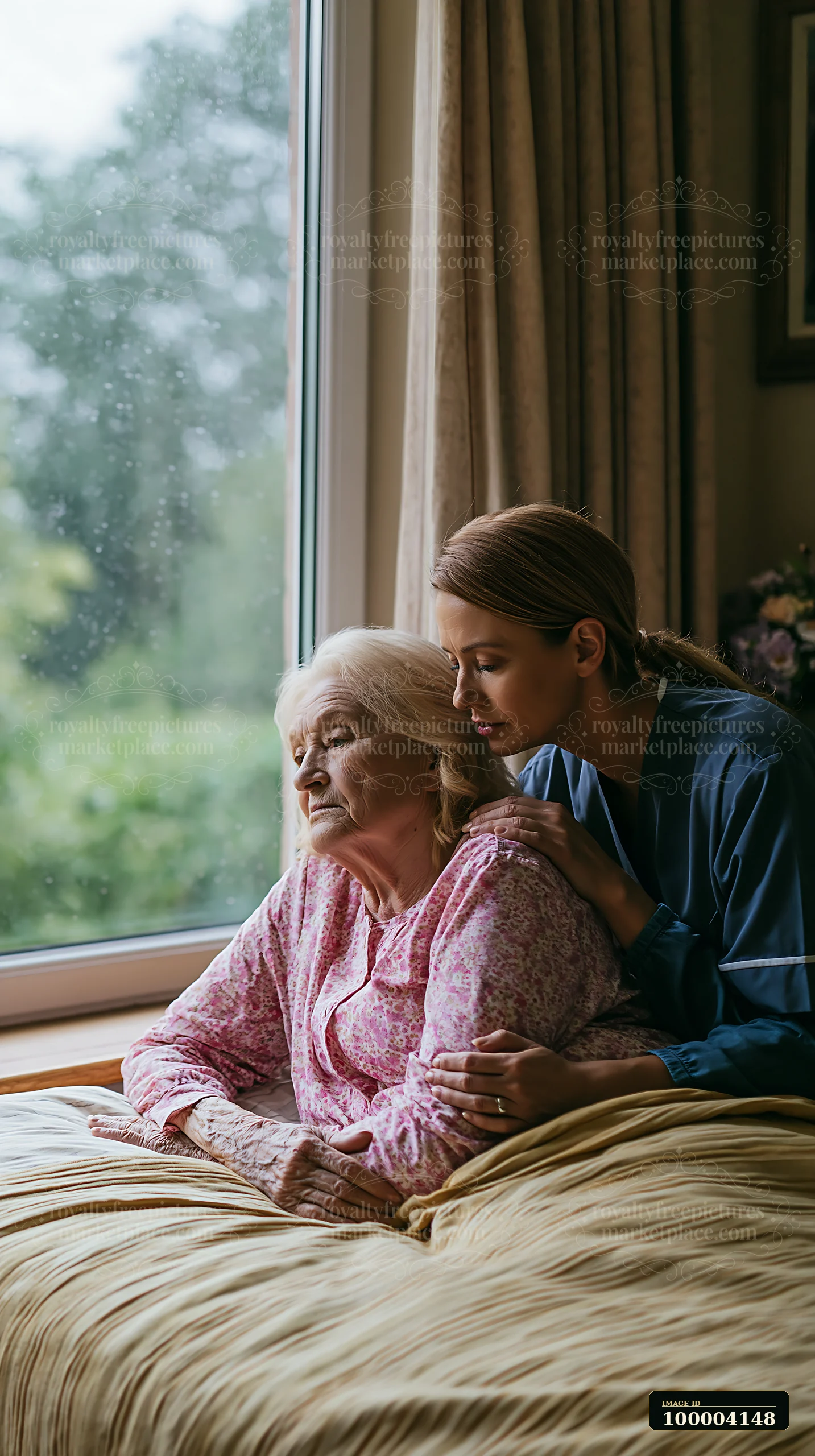 Caregiver gently supports an elderly woman sitting in bed beside a window at home.