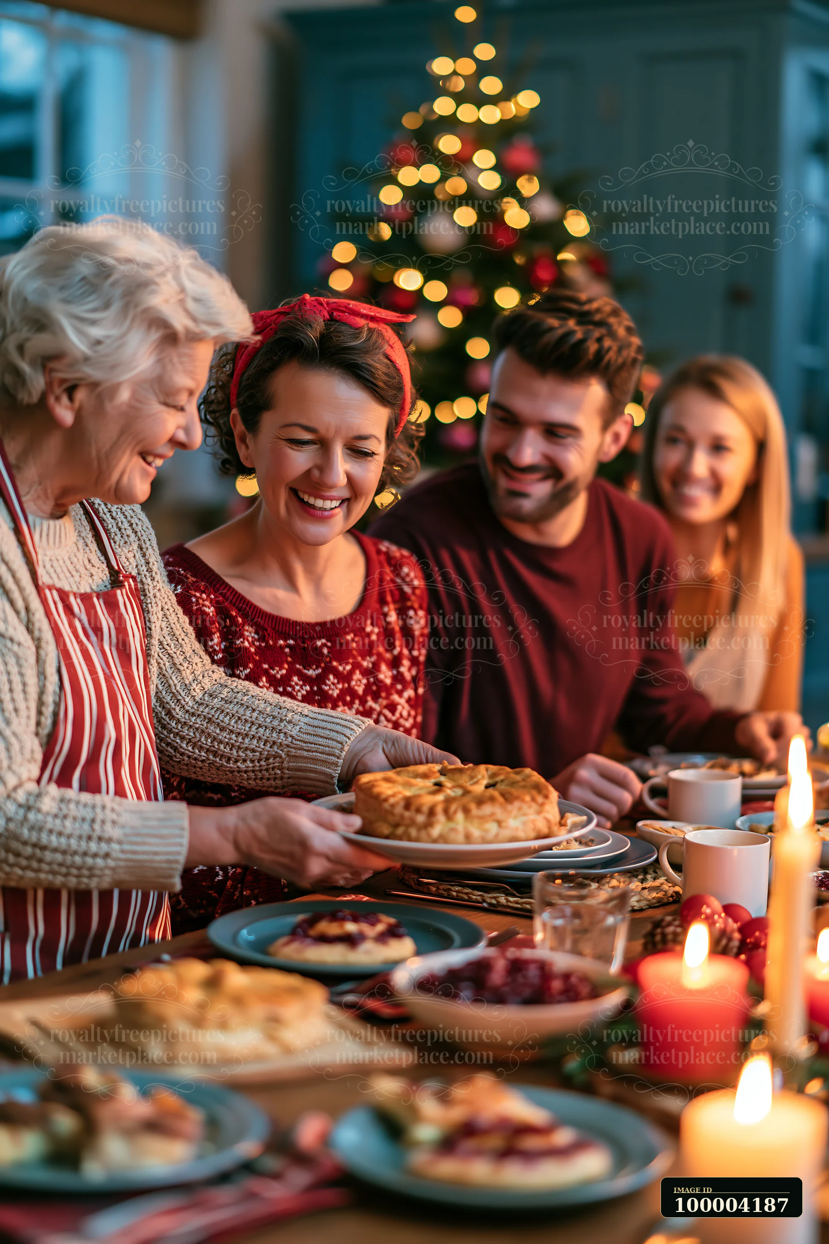 Four family members share a festive breakfast around a table beside a lit Christmas tree.