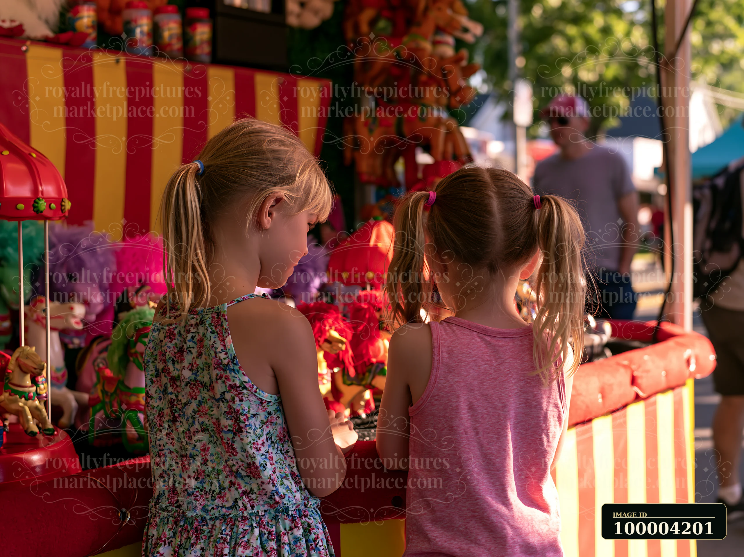 Two children observe various toys displayed at a carnival booth, excited about selecting their prizes.