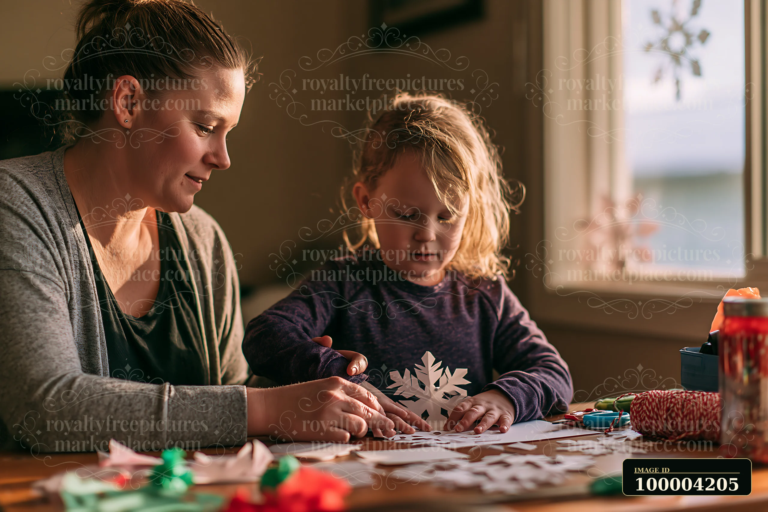 A mother and her child create paper snowflakes together at a table in their home.