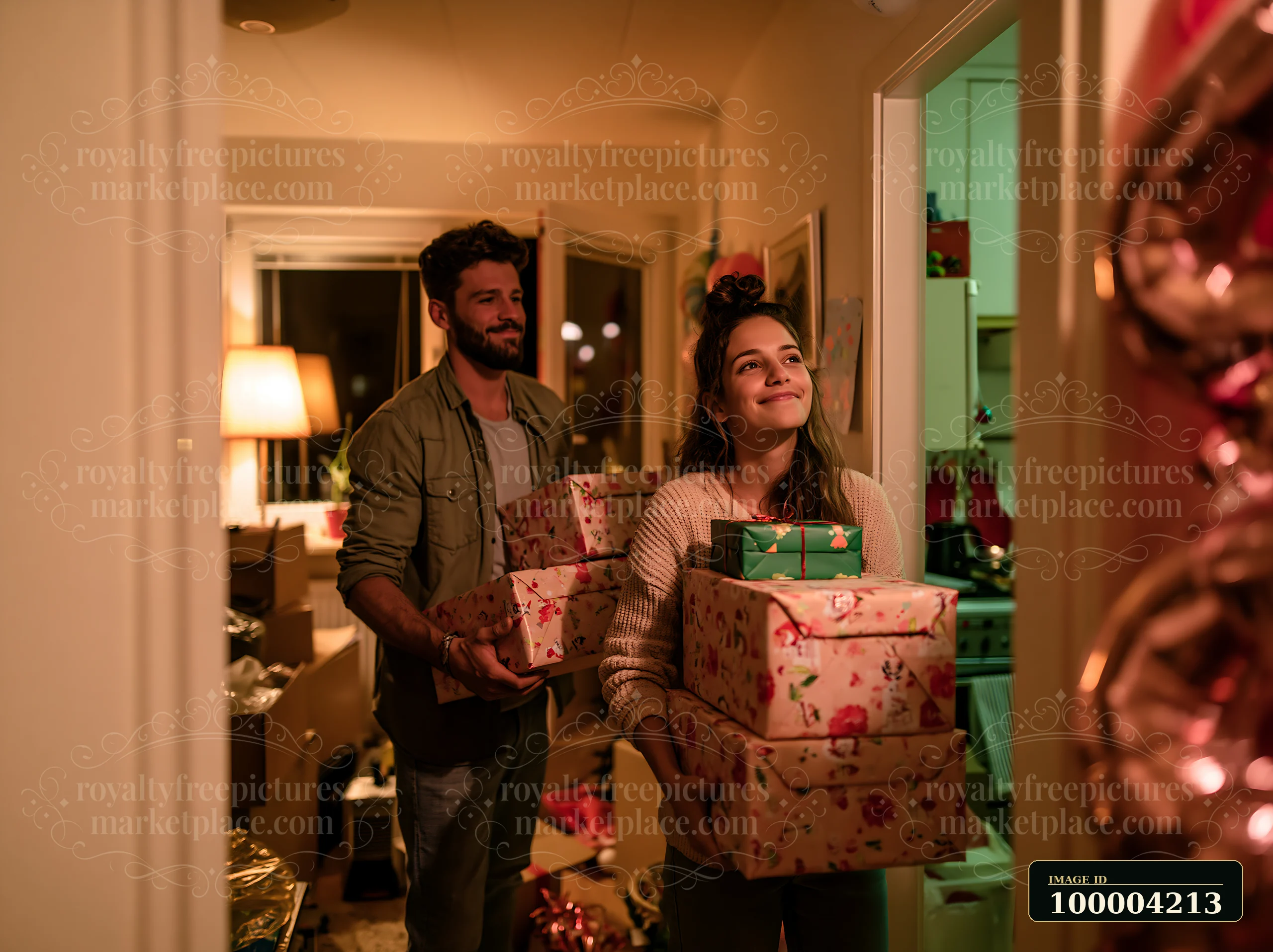 Two parents carry decorated gift boxes through a warmly lit home during the holidays.