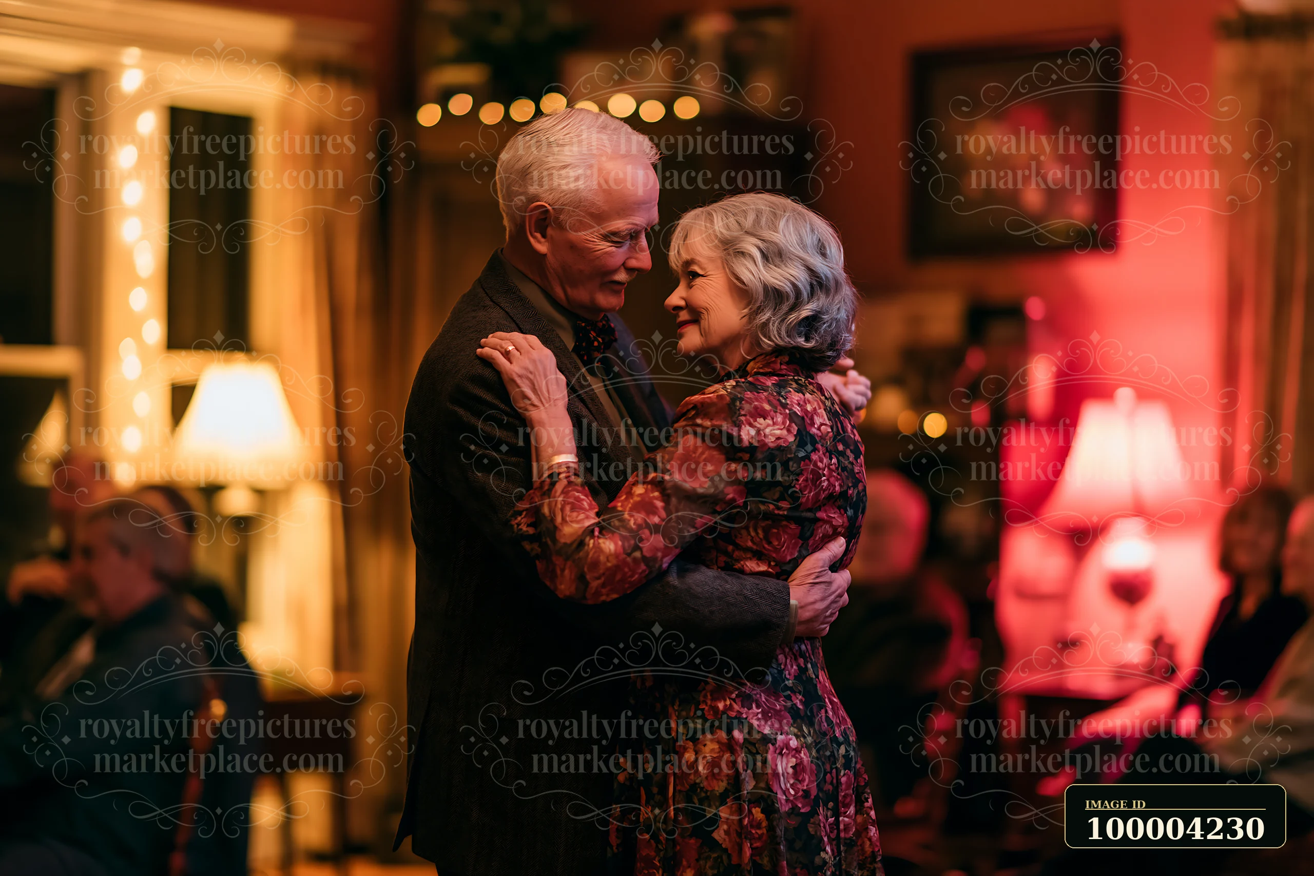 An elderly couple dances slowly together in their cozy living room, surrounded by warm lighting and seated guests.