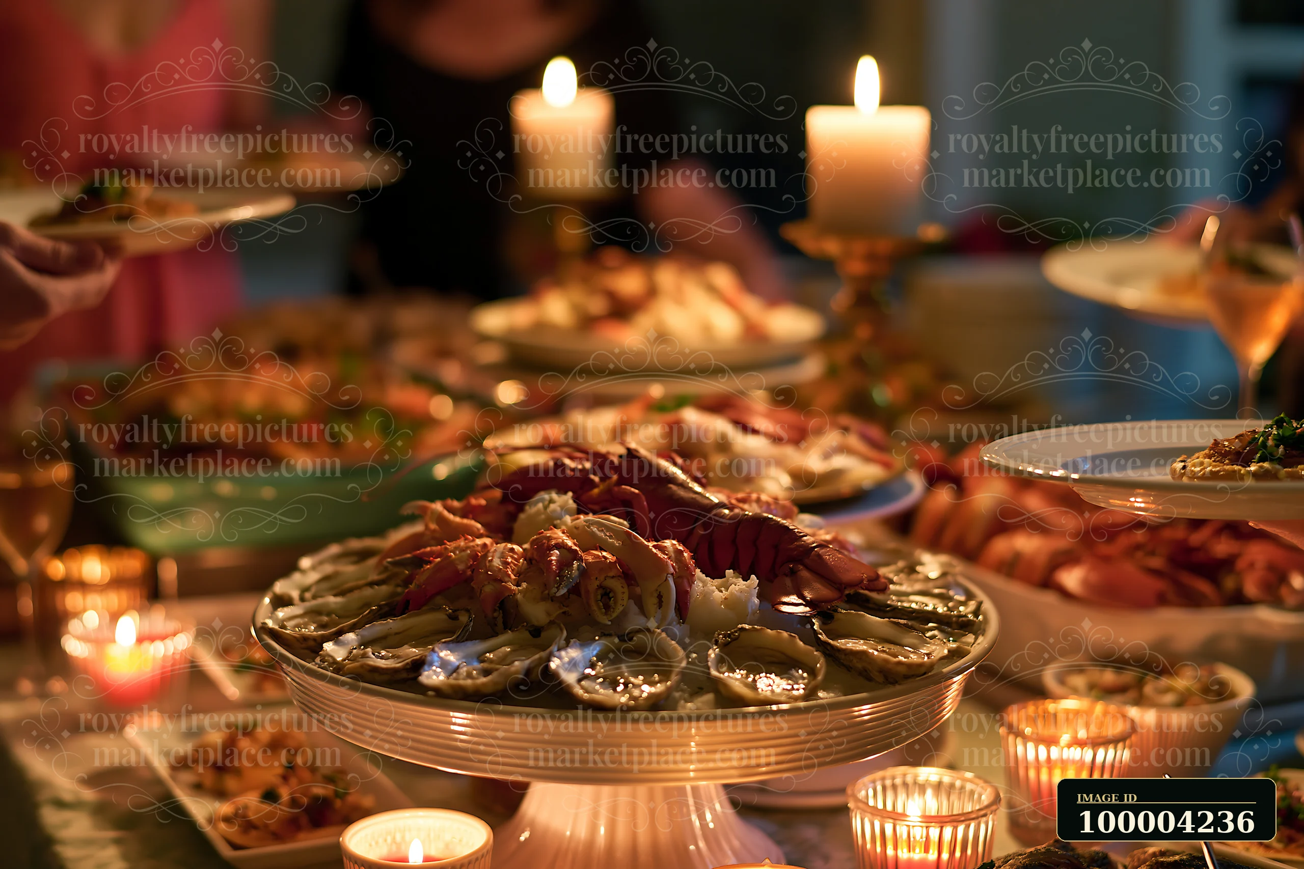 Chilled seafood buffet display with oysters, lobster, and crab surrounded by candles and plated dishes.